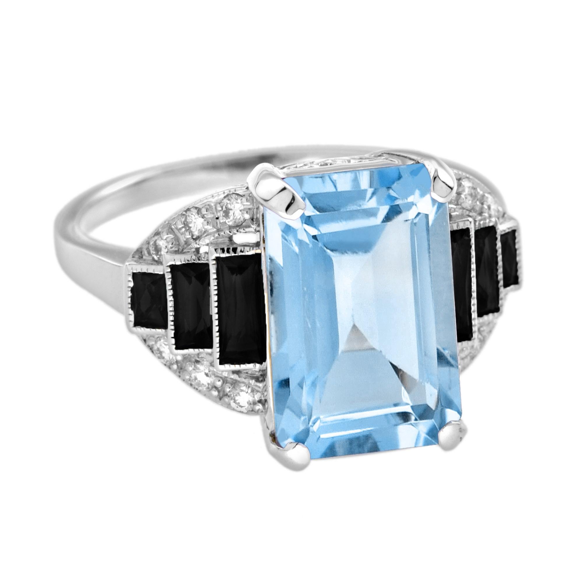Entra in un regno di eleganza senza tempo con il nostro squisito anello a spalla con diamante di Topazio Blu e Onice in stile Art Deco. Questo splendido pezzo presenta un affascinante topazio blu dal taglio smeraldo, incastonato ad arte per