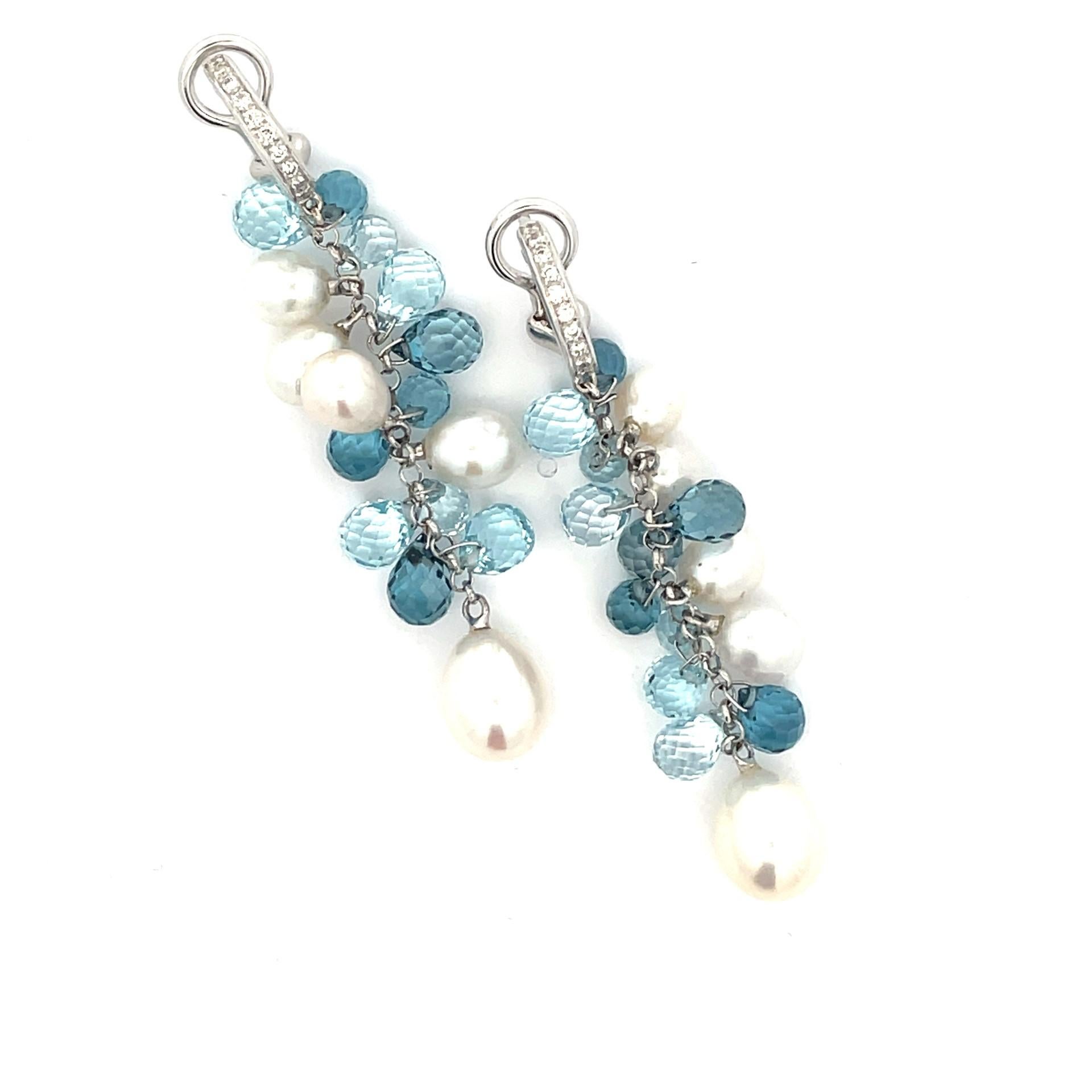 A pair of fun hanging earrings in 18kt white gold with  diamonds, pearls and 22  blue topaz briolettes of the finest quality. 

24 brilliant cut diamond  0.23ct total weight

22 blue topaz briolette 26.92ct total weight

10 Pearls, measuring 6x7mm -