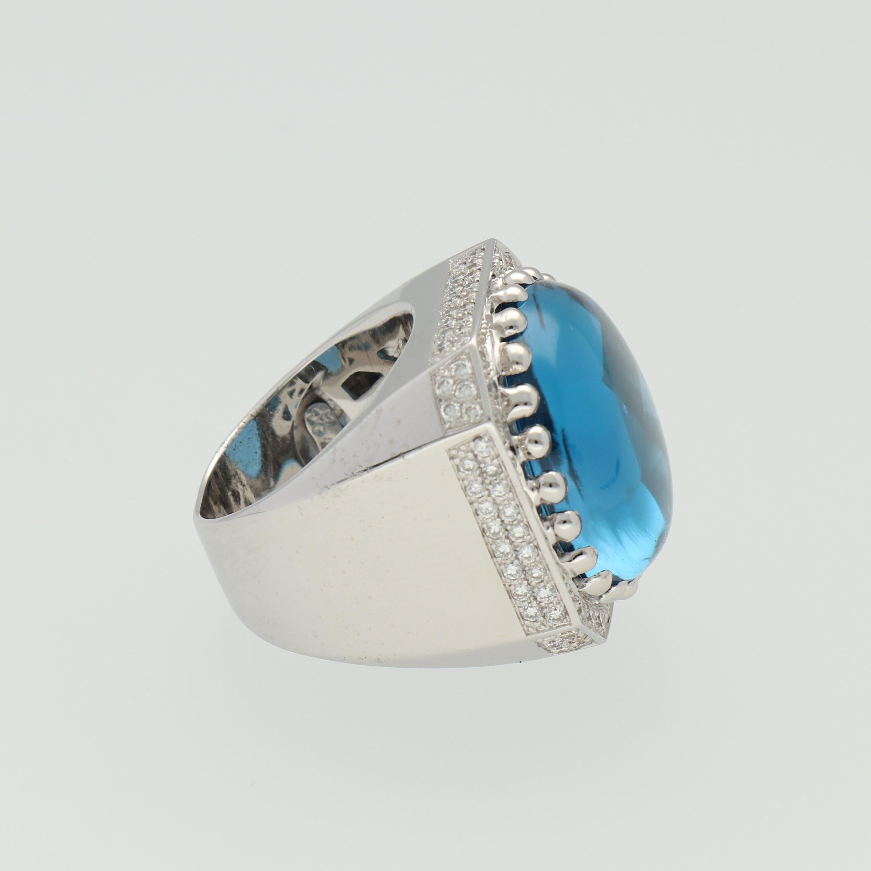 A 18 mm diameter Blue Topaz faceted back cabochon, with approximately 1.15 carat round-cut diamonds mounted in an 18K White Gold Cocktail Ring.

Size US 7 - 54.4 mm

Components:
18K white gold weigh approximately - 20 grams
1 Topaz - 18 mm diameter