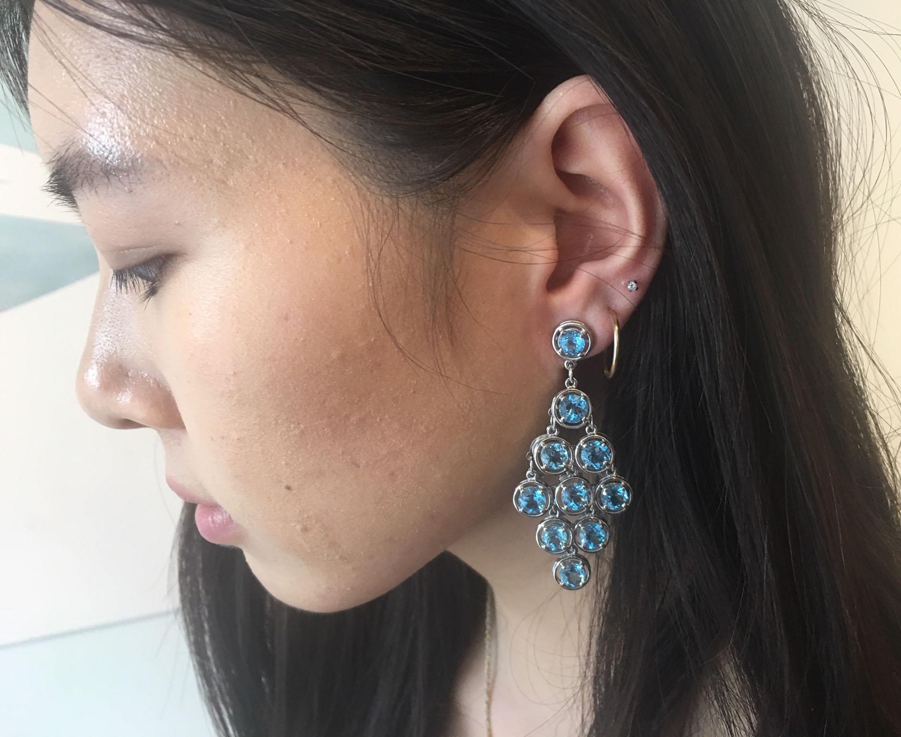 Sensational Chandelier Earrings set with twenty round faceted Blue Topaz mounted in 14k white gold handmade 4-claw setting with post and butterfly closure; A perfect complement to every wardrobe… Illuminating your Look with a touch of class!
