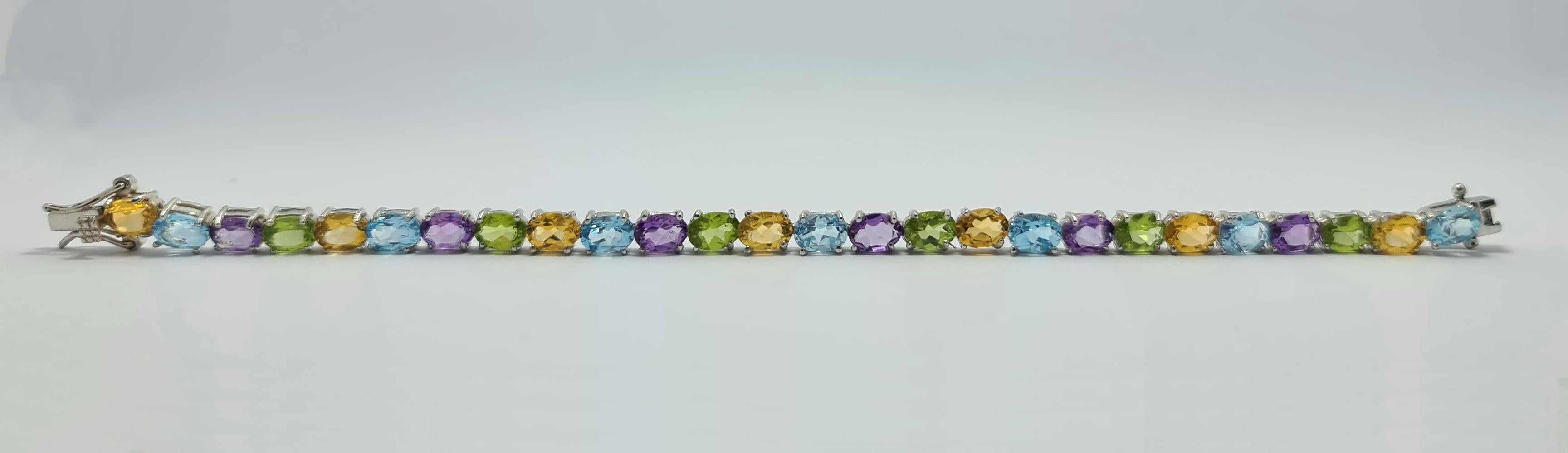 Brand New Sterling Silver Tennis Bracelet with Natural Blue Topaz, Citrine, Amethyst, and Peridot.
Sterling Silver is Rhodium Plated.
The Length is 7 inches.
The weight is 16 grams