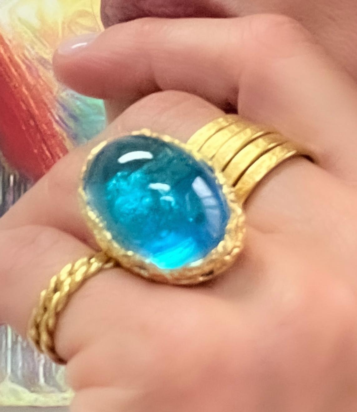 Dive deep into the deep blue color of this fabulous blue topaz cocktail ring set in 22k gold. This stunner is hand carved with cut outs to show the stone from every angle while maintaining a classic bezel setting. You will look and feel like a queen
