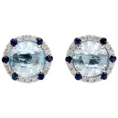 Clous d'oreilles rondes en or 18 carats avec topaze bleue et diamant