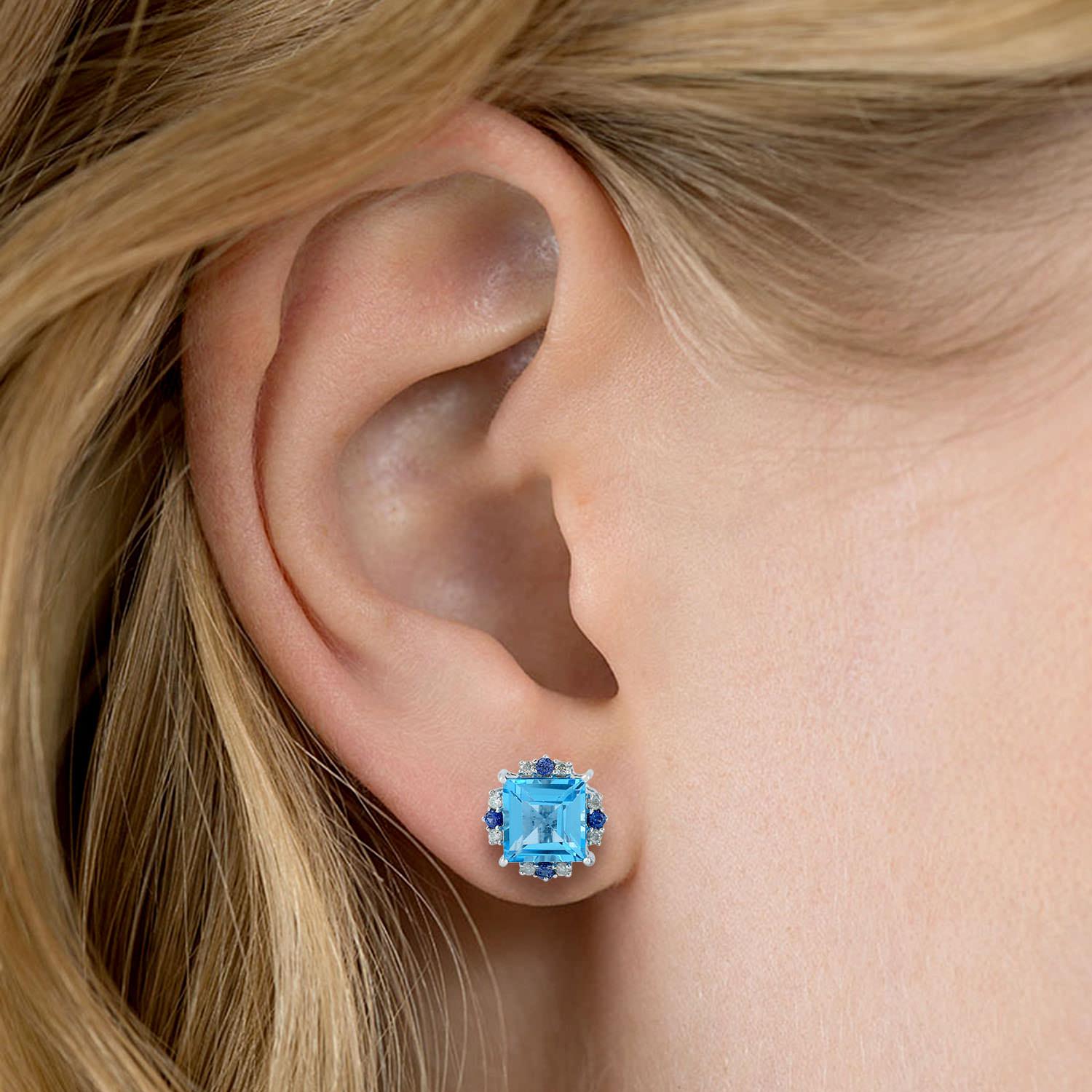 Cast from 18-karat gold.  These beautiful stud earrings are hand set with 4.11 carats blue topaz, .20 carats blue sapphire & .14 carats of sparkling diamonds.  

FOLLOW  MEGHNA JEWELS storefront to view the latest collection & exclusive pieces. 