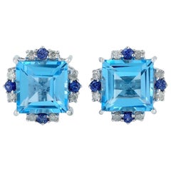 Clous d'oreilles en or 18 carats avec topaze bleue et diamants