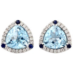 Clous d'oreilles en or 18 carats avec topaze bleue et diamants
