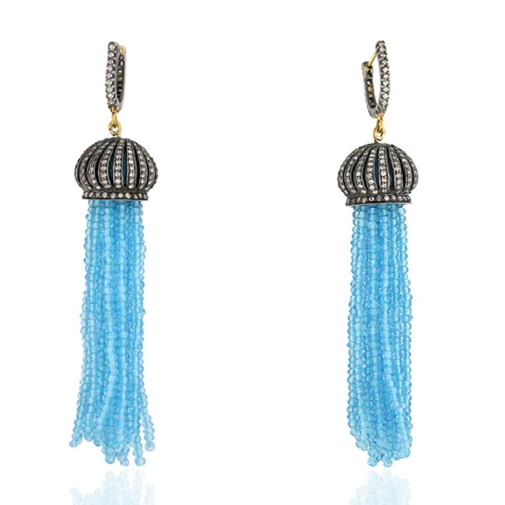 Designer Blue Topaz and Diamond Tassel Earring in Gold and Silver 

18kt gold: 0.7gms
Silver:10.18g
Diamond: 3.1cts
Topaz Blue: 115.7cts
