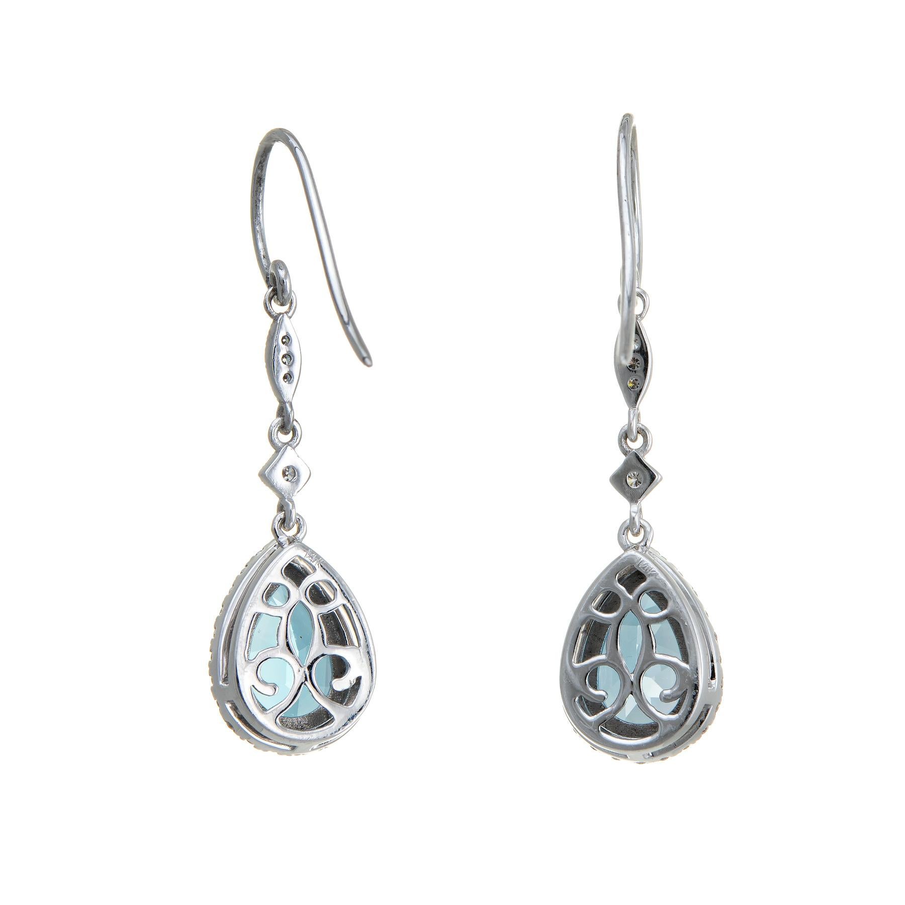 Elegant pair of estate blue topaz & diamond drop earrings, crafted in 14k white gold. 

Pear shaped blue topaz measures 10mm x 7mm (estimated at 2 carats each - 4 carats total estimated weight). The diamonds total an estimated 0.28 carats (estimated