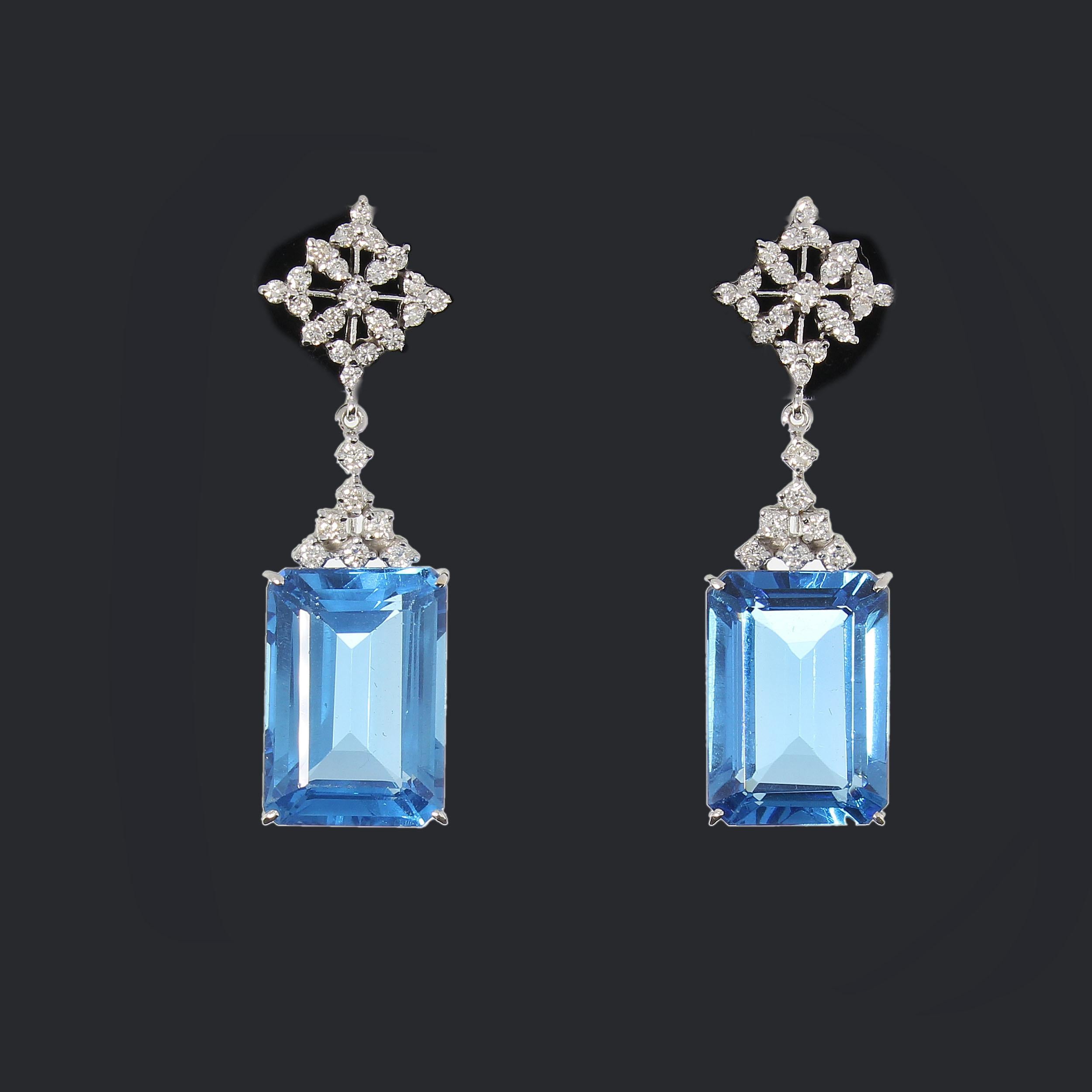 Europe about 2000. Set with 2 blue emerald-cut topaz weighing 69,0 ct. and 56 brilliant-cut diamonds weighing 1,90 ct. Prong setting. Mounted in 14 K white gold. Total weight: 20,34 g. Length: 1.97 in ( 5 cm )