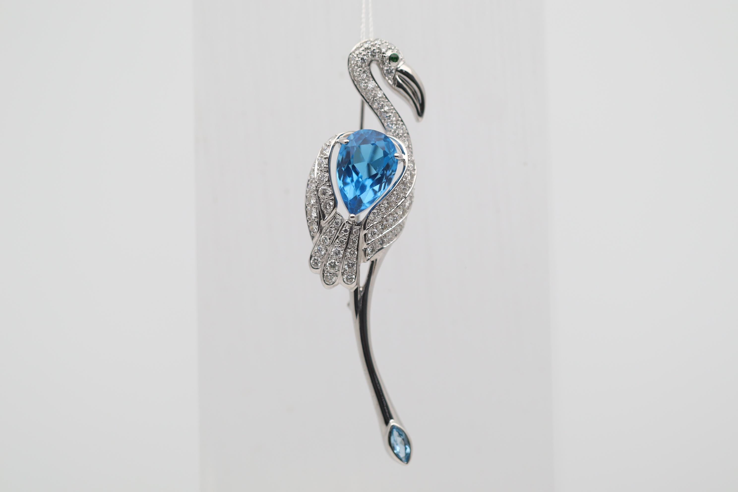 A chic and classy brooch featuring a long and slender flamingo posing in stylish manner. Its wing is made of a 8.34 carat pear-shape blue topaz which is rich and intense in its color and clarity. Adding to that the rest of the flamingo's body is