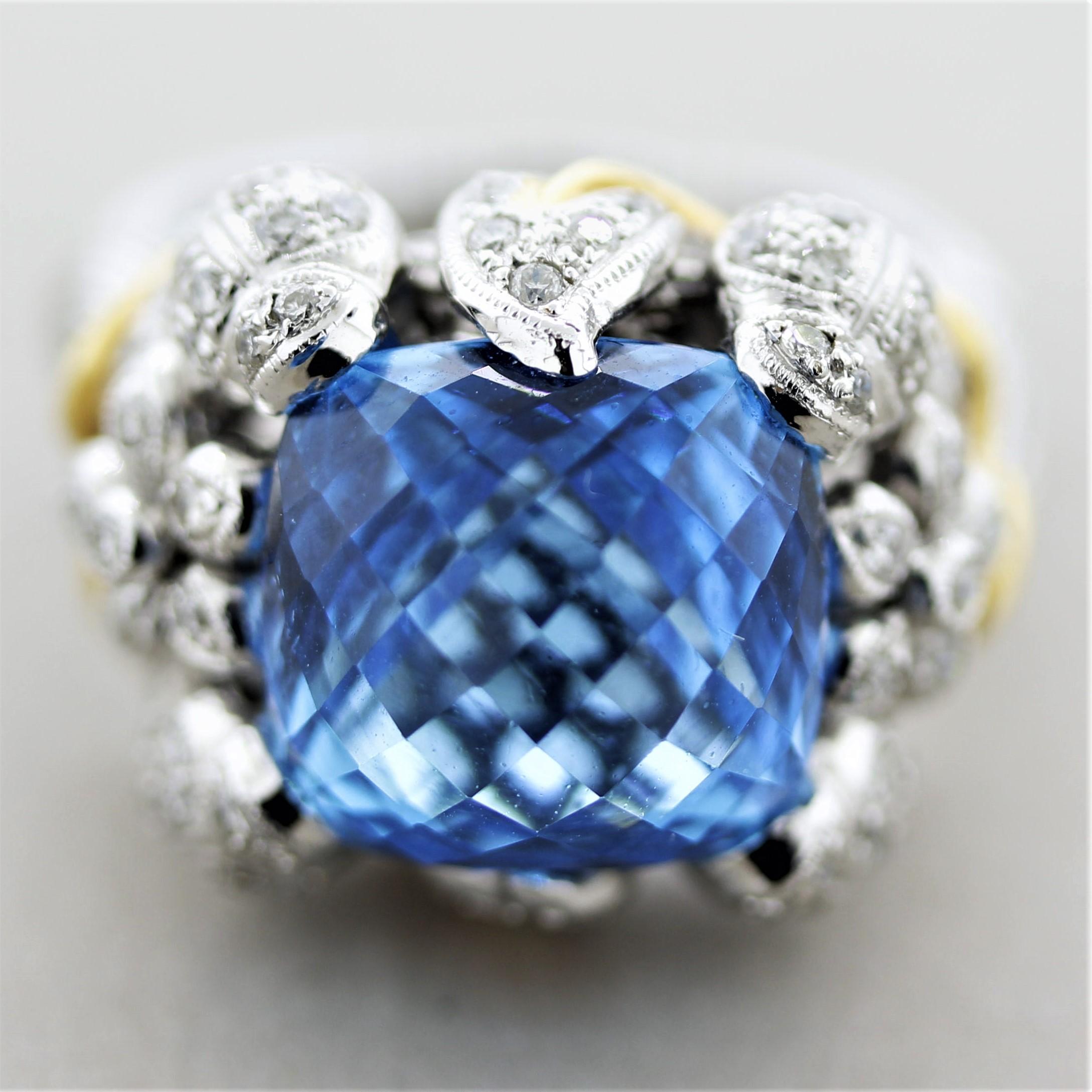 A sweet and stylish ring featuring a 8.60 carat topaz. It has a strong bright blue color and was cut into a unique dome faceted shape. It is accented by 0.74 carats of round brilliant-cut diamonds which are set into various leaves, flowers, and