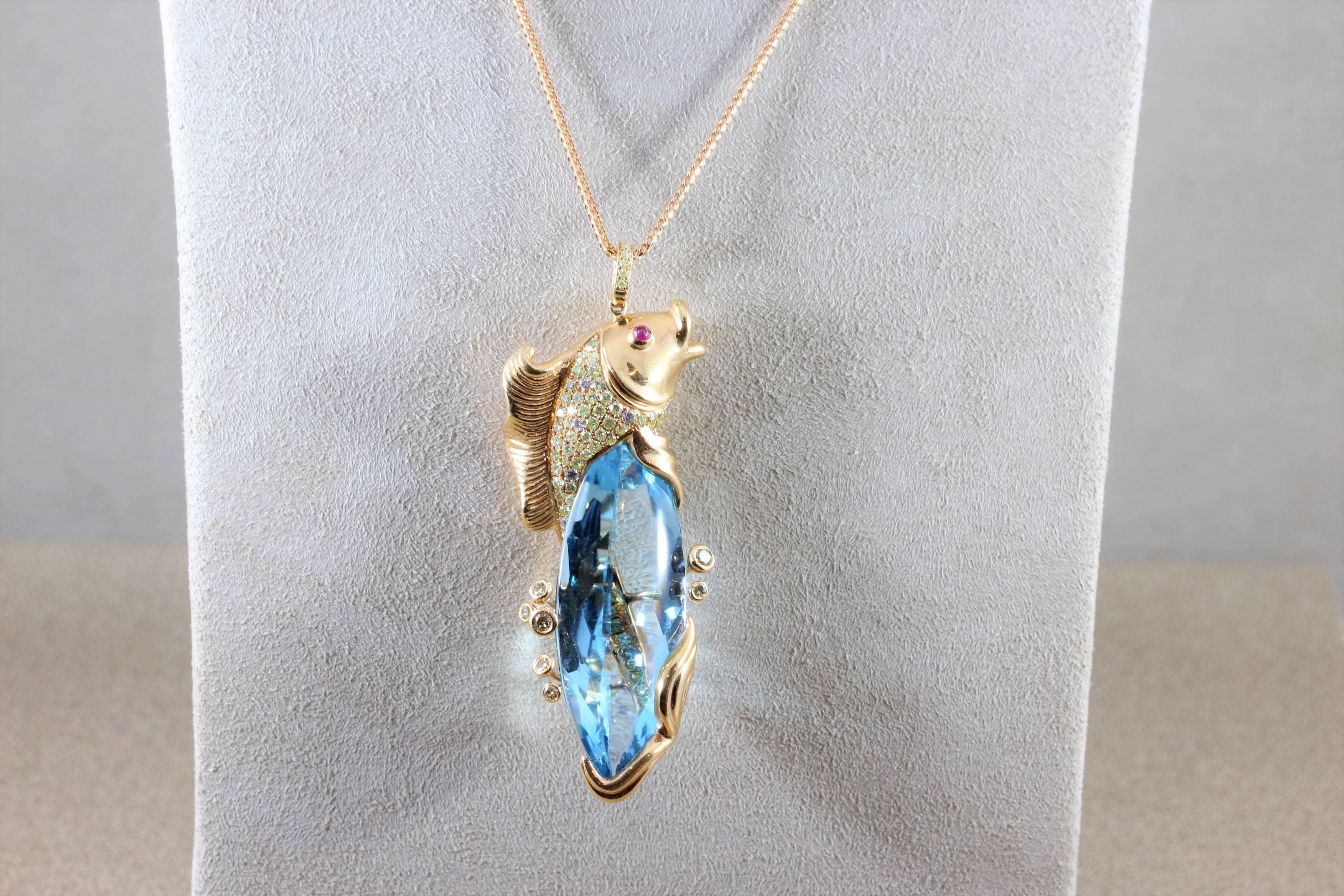 A uniquely beautiful rose gold pendant featuring a fine 41.90 carat blue topaz. The gemstone is surrounded by a diamond studded koi fish that wraps around the stone. The 18K rose gold koi fish has two ruby cabochon eyes.

Pendant Length: 2 inches