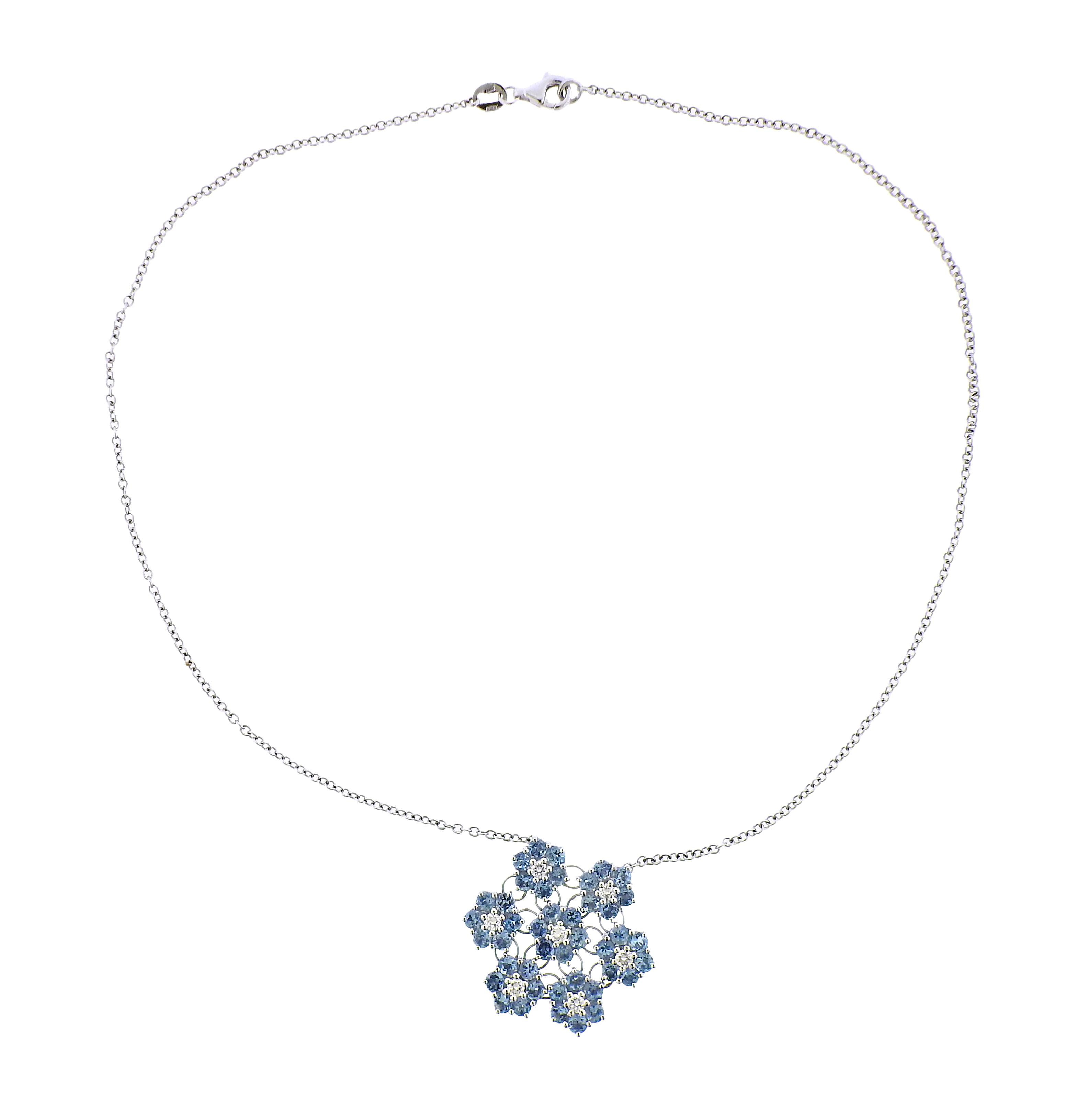 18k white gold pendant necklace, featuring blue topaz and diamond flowers. Diamonds approx. 0.56ctw. Necklace is 16