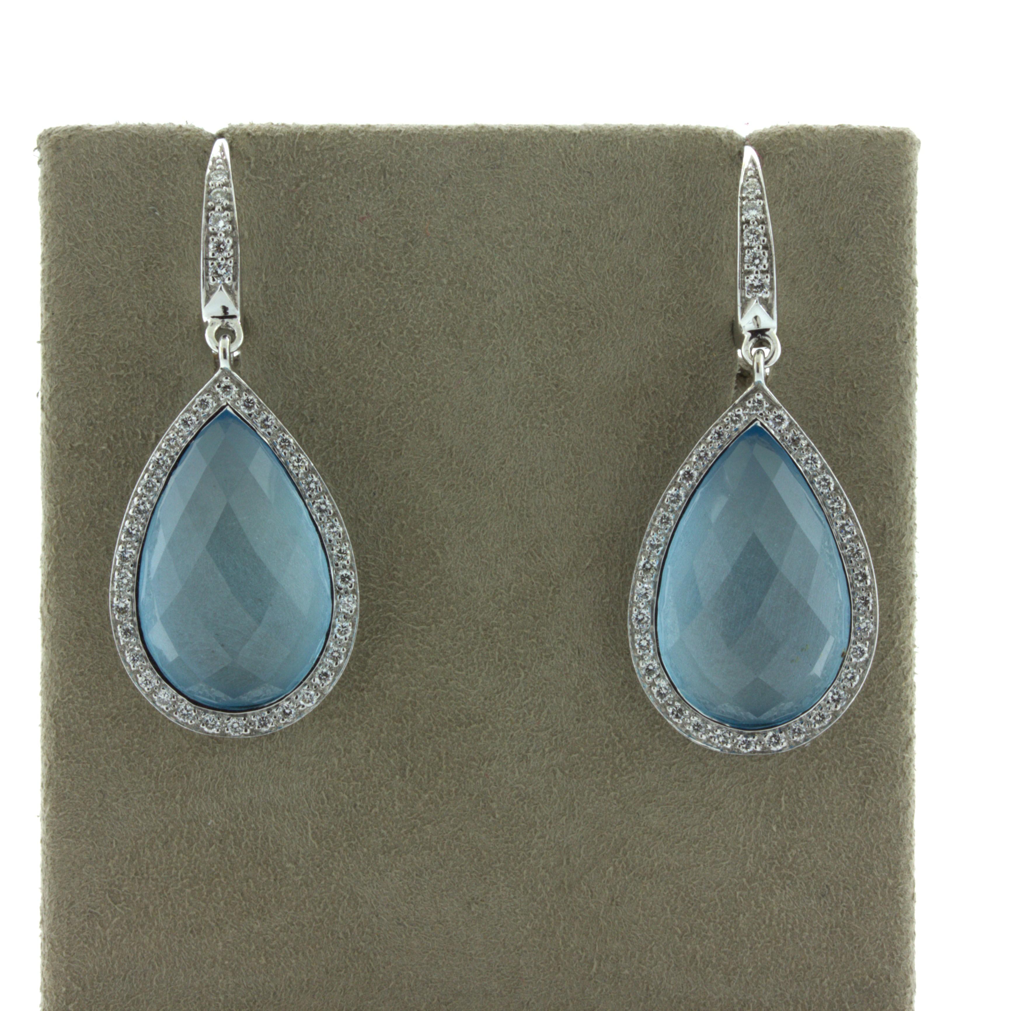 An elegant and classy pair of earrings featuring pear-shaped rose-cut blue topaz! The topaz weigh a total of 22.94 carats and have a lovely pear-shape with a rose-cut cabochon finish giving the stones added uniqueness. They are haloed by round