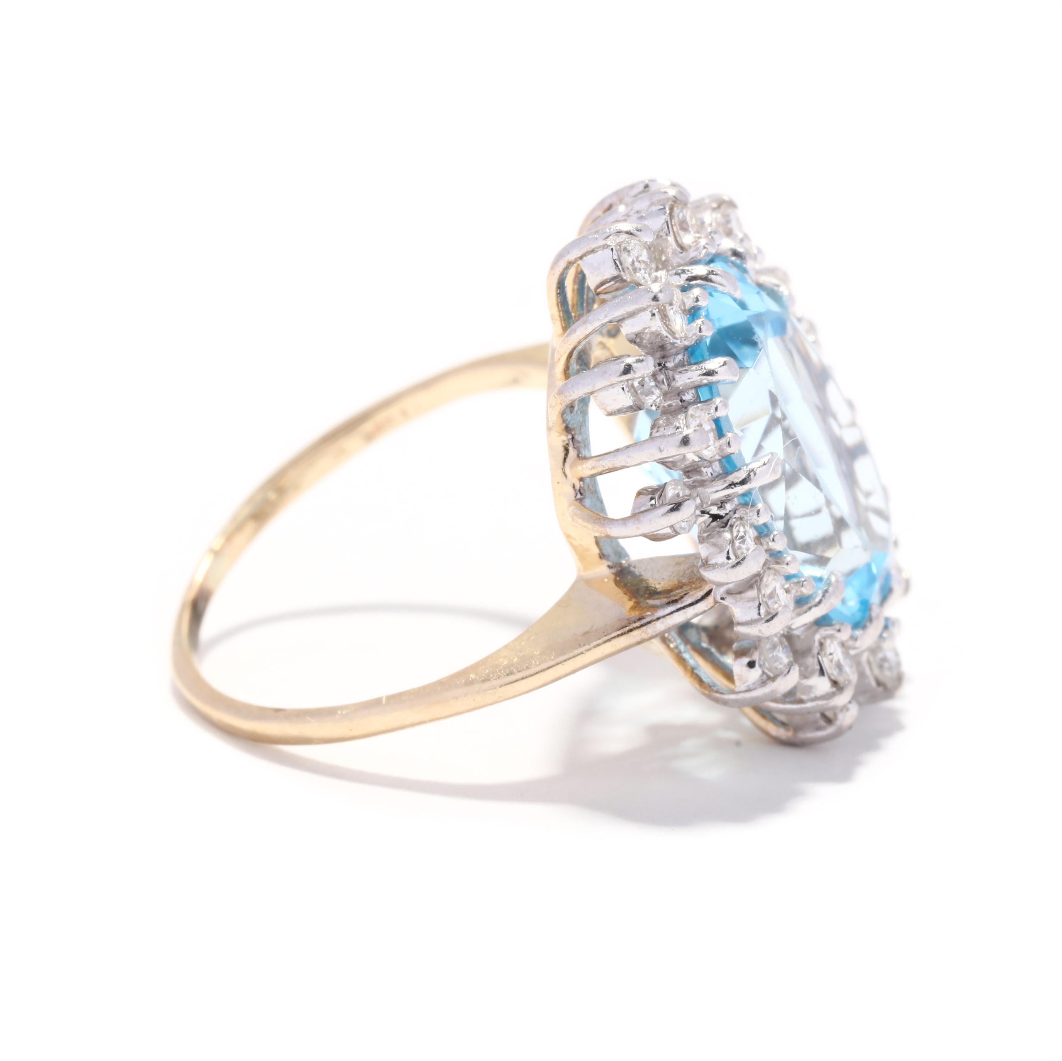 A vintage 14 karat yellow gold blue topaz and diamond halo cocktail ring. This December birthstone ring features a large prong set, oval cut blue topaz center stone weighing approximately 6.37 carat surrounded by a halo of round brilliant cut