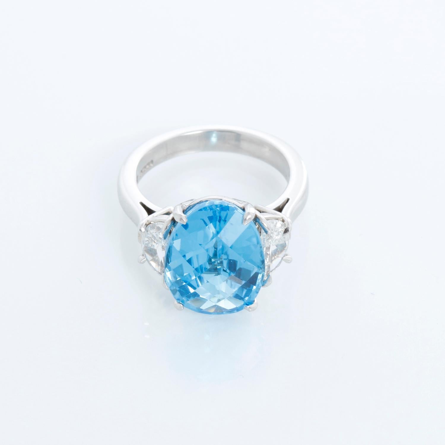 Beautiful blue topaz with two half moon in diamonds. Total carat weight .87. Diamond Color G, Clarity SI1. Topaz size 14.5 mm x 11. New with ring box