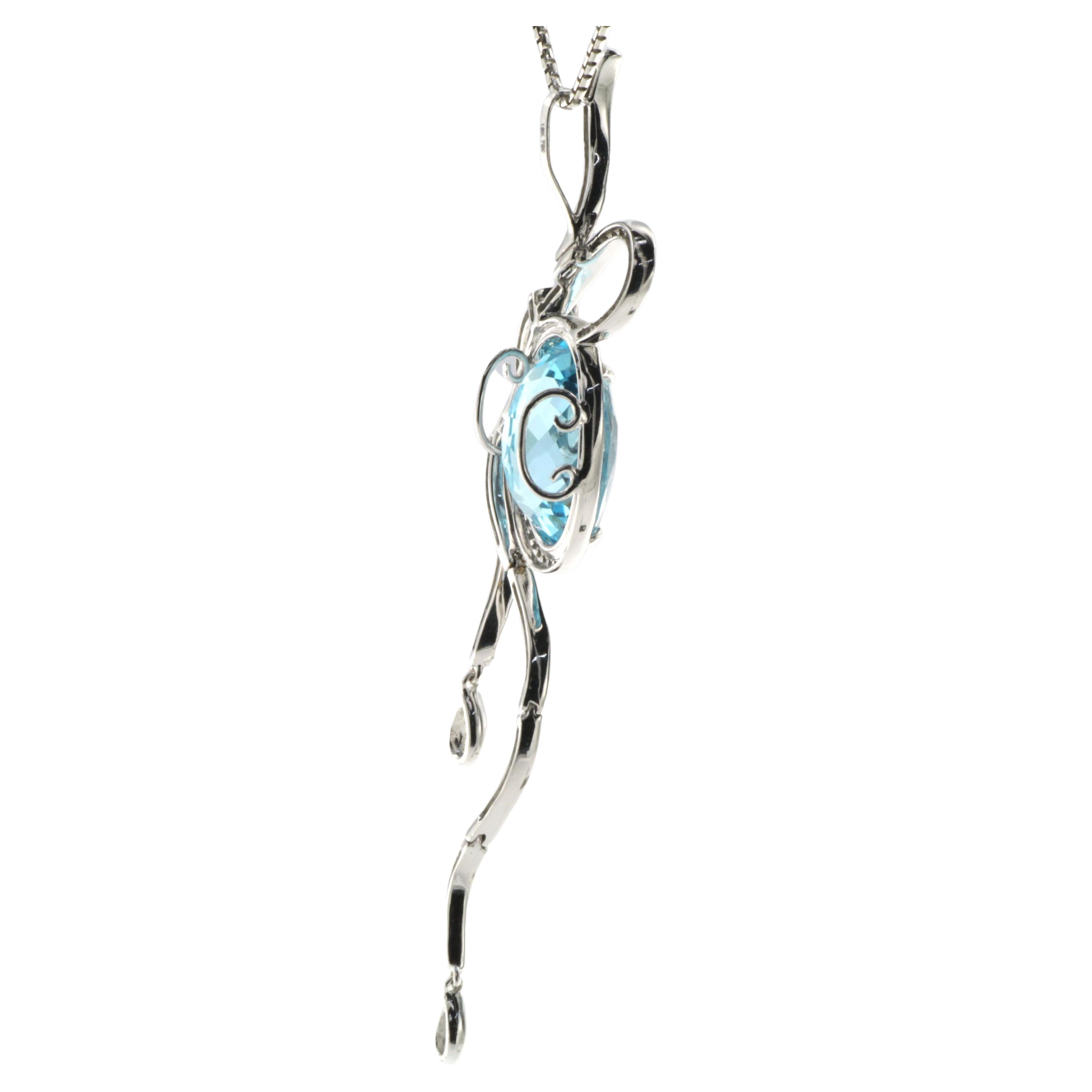 This pendant features 11.18 carat of oval shape blue topaz, the blue topaz is surrounded by a diamond halo. The diamonds and 18 karat white gold also form a ribbon attached to the center blue topaz. Total carat weight 0.76 carat of white round