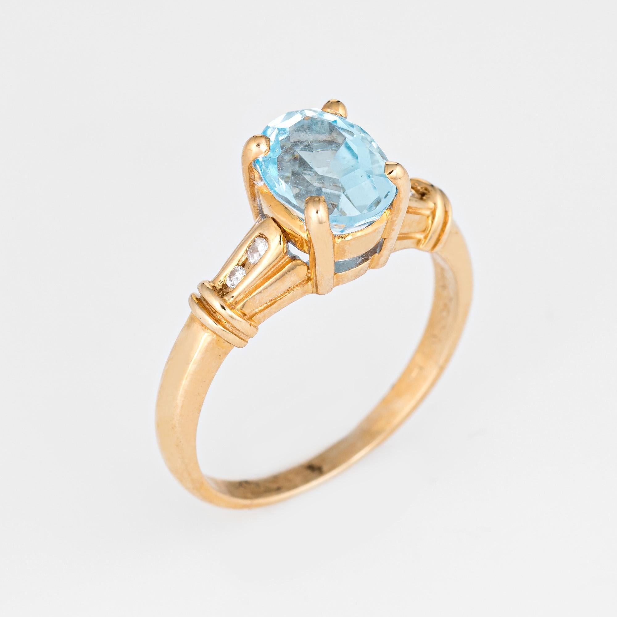 Stylish blue topaz & diamond small cocktail ring crafted in 14 karat yellow gold. 

Faceted oval blue topaz measures 8mm x 6mm (estimated at 1 carat) is accented with 0.04 carats of diamonds (estimated at H-I color and SI1-2 clarity). The topaz is