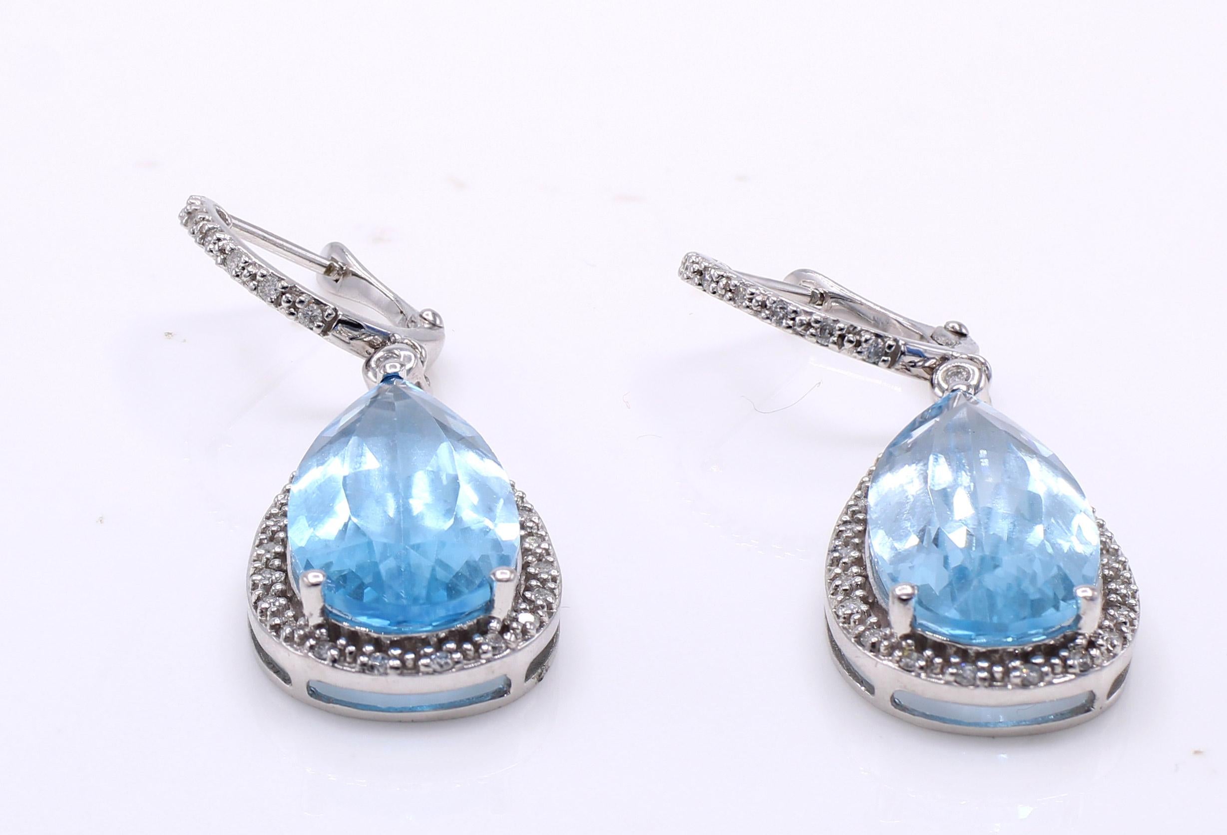 Two perfectly matched and wonderfully cut London blue topaz pear shapes are the center pieces of this gorgeous pendant earrings. The gemstones have a beautiful deep aquamarine color  and are full of life and brilliance. Set in a white gold mounting