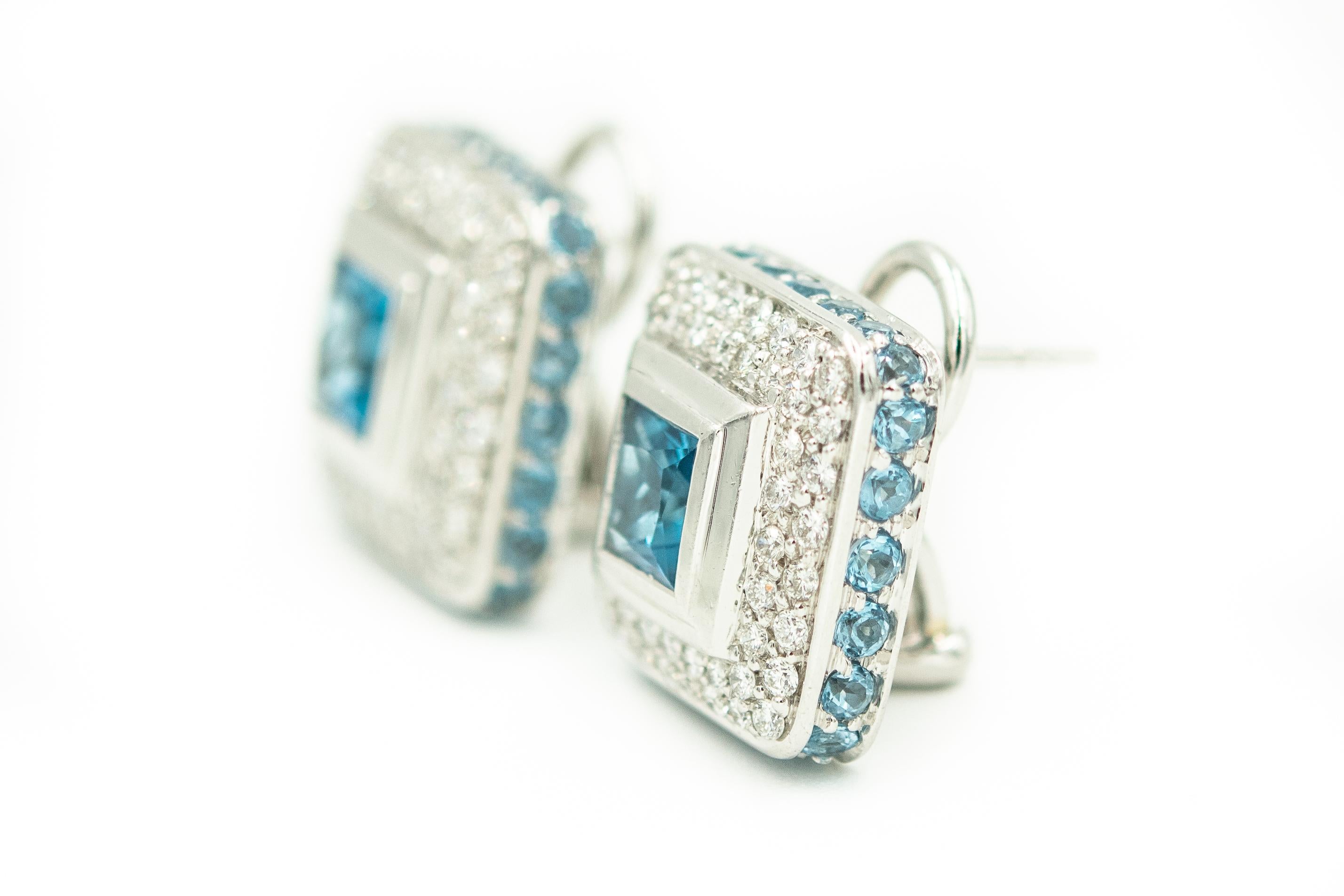 Beautifully made 18k white gold square earrings featuring a centrally set square blue topaz in a double row of bead set diamonds.  The blue topaz are approximately 1.25 carats each.  The outer edge is finished off with bead set small round blue