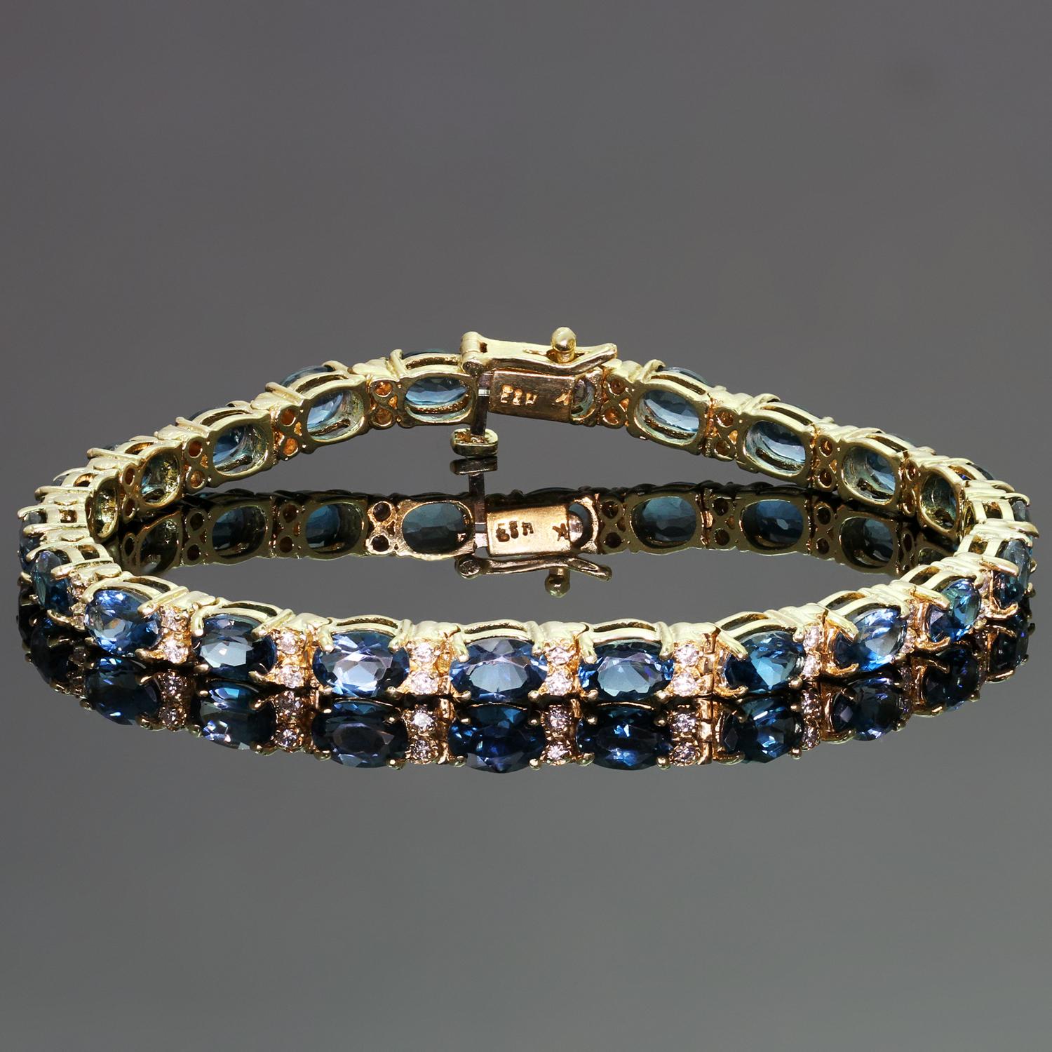This gorgeous oval link bracelet is crafted in 14k yellow gold and set with blue topaz stones weighing an estimated 11.00 carats and brilliant-cut round diamonds weighing an estimated 0.88 carats. Made in United States circa 1990s. Measurements: