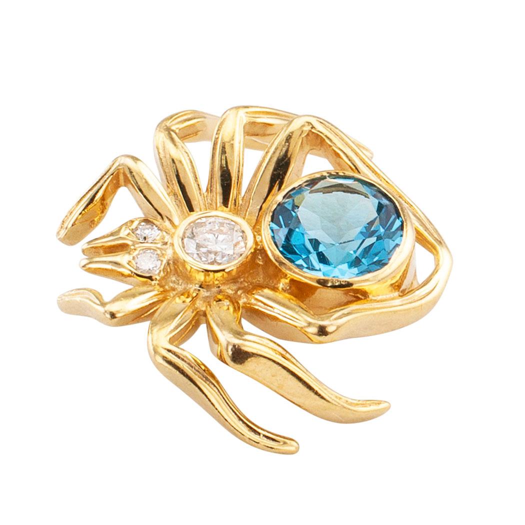 Blue topaz diamond and gold spider brooch circa 1970. The figural design depicting a spider, its body set with a large round blue topaz and three smaller round brilliant-cut diamonds totaling approximately 0.12 carats, crafted in 14-karat yellow