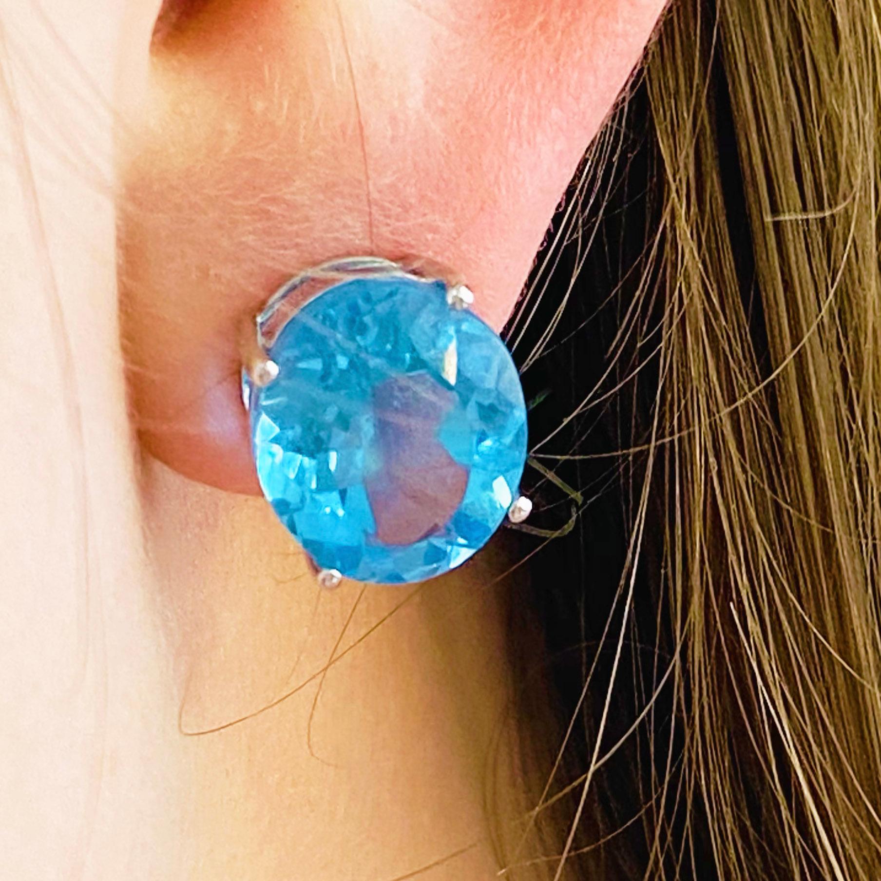 These blue topaz earrings are a modern design set in 14 karat white gold! Each earrings holds an oval cut, genuine blue topaz gemstone set in four white gold prongs. Blue topaz is the birthstone for December making these the perfect birthday gift or