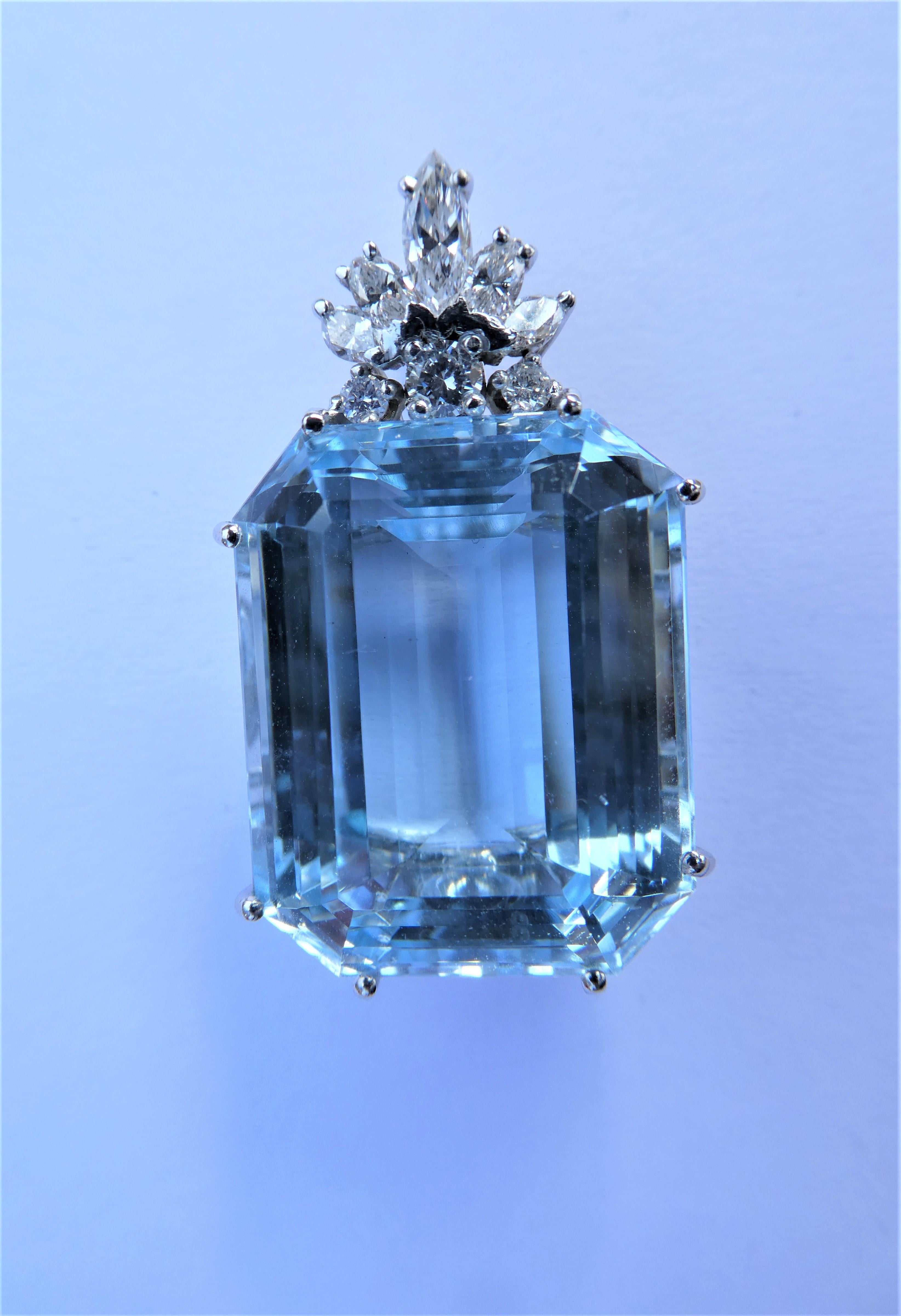 The emerald cut Topaz weighs 48.8 carat and has a vibrant blue colour. It looks a bit like an aquamarine but it comes with a certifcate saying that it is a blue topaz octagon. It was crafted in 18 karat white gold ( Two stamps of 750) in Germany in