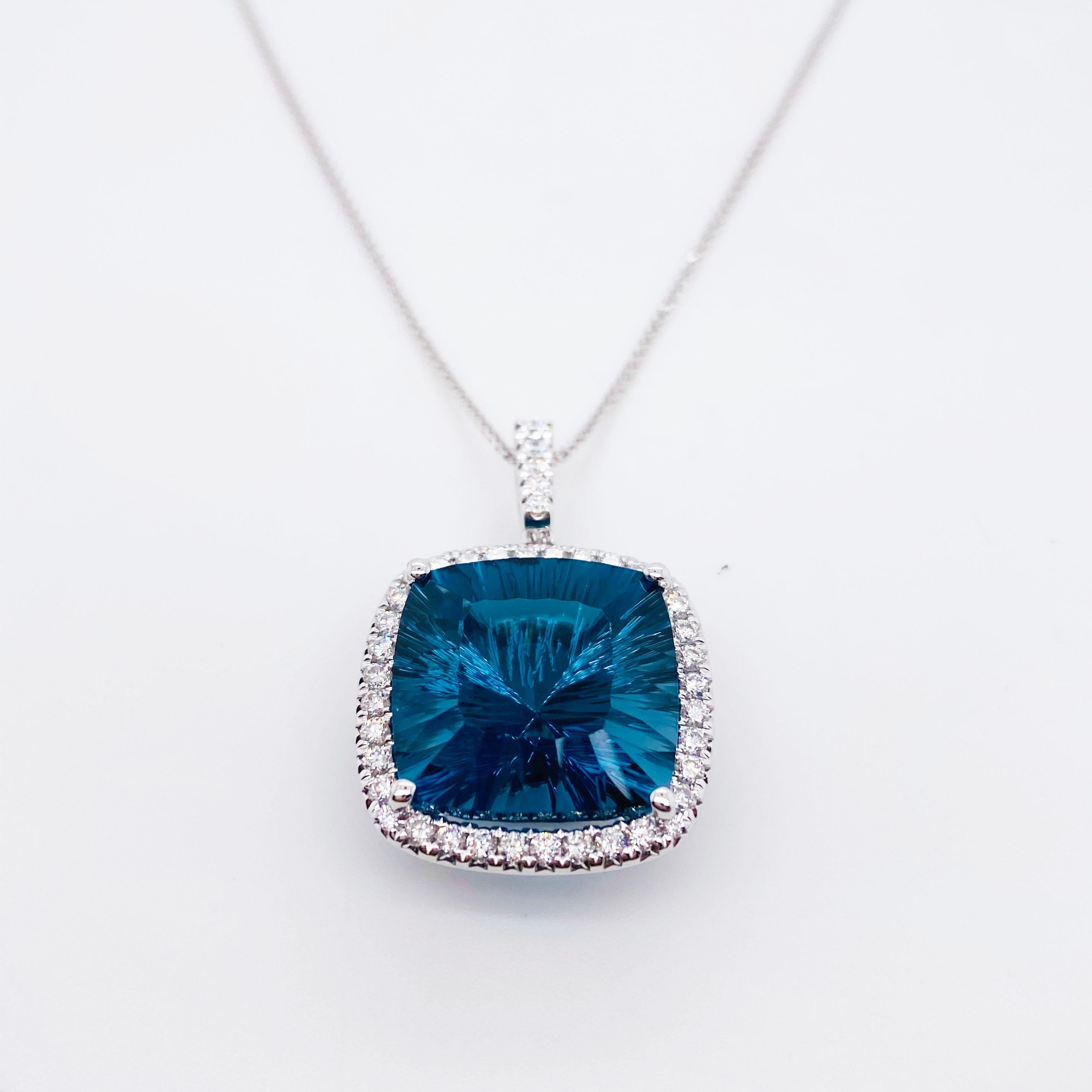 This Brazilian Fantasy Gemstone was very carefully cut by a well known cutter in Brazil. The London Blue Topaz is so sleek and has amazing reflections. The gemstone is outlined by the row of diamonds and the diamonds on the bail and set beautifully