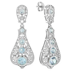Pendientes colgantes de filigrana de topacio azul en oro blanco de 14 quilates