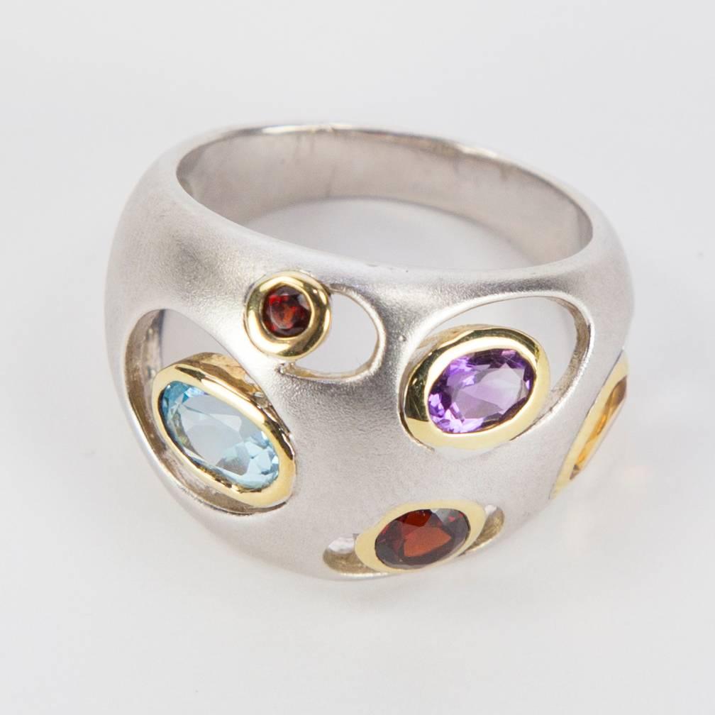 Bold and Beautiful Dome Multi-stone Ring Features Blue Topaz, Garnet, Amethyst and Citrine; bezel set in Gilt Sterling Silver. Hand crafted in Sterling Silver; the top dome of ring measures approx. 1 inch in length x 0.75 inches wide. Ring size 6.5.