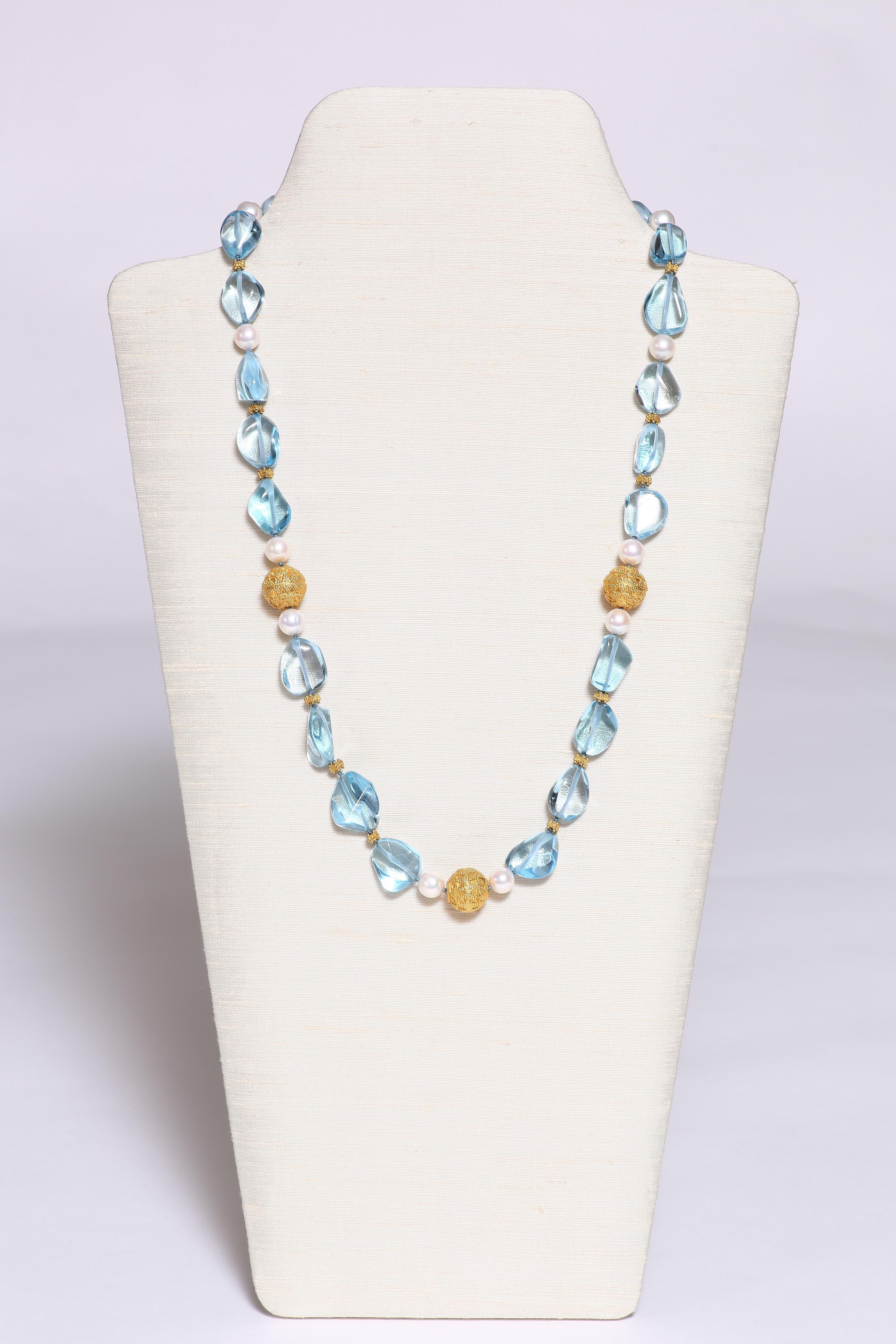 An exquisite necklace with clear blue topaz, round gold beads and freshwater peals. The bright clear topaz colouring is exquisite and makes a stunning summer necklace. 25