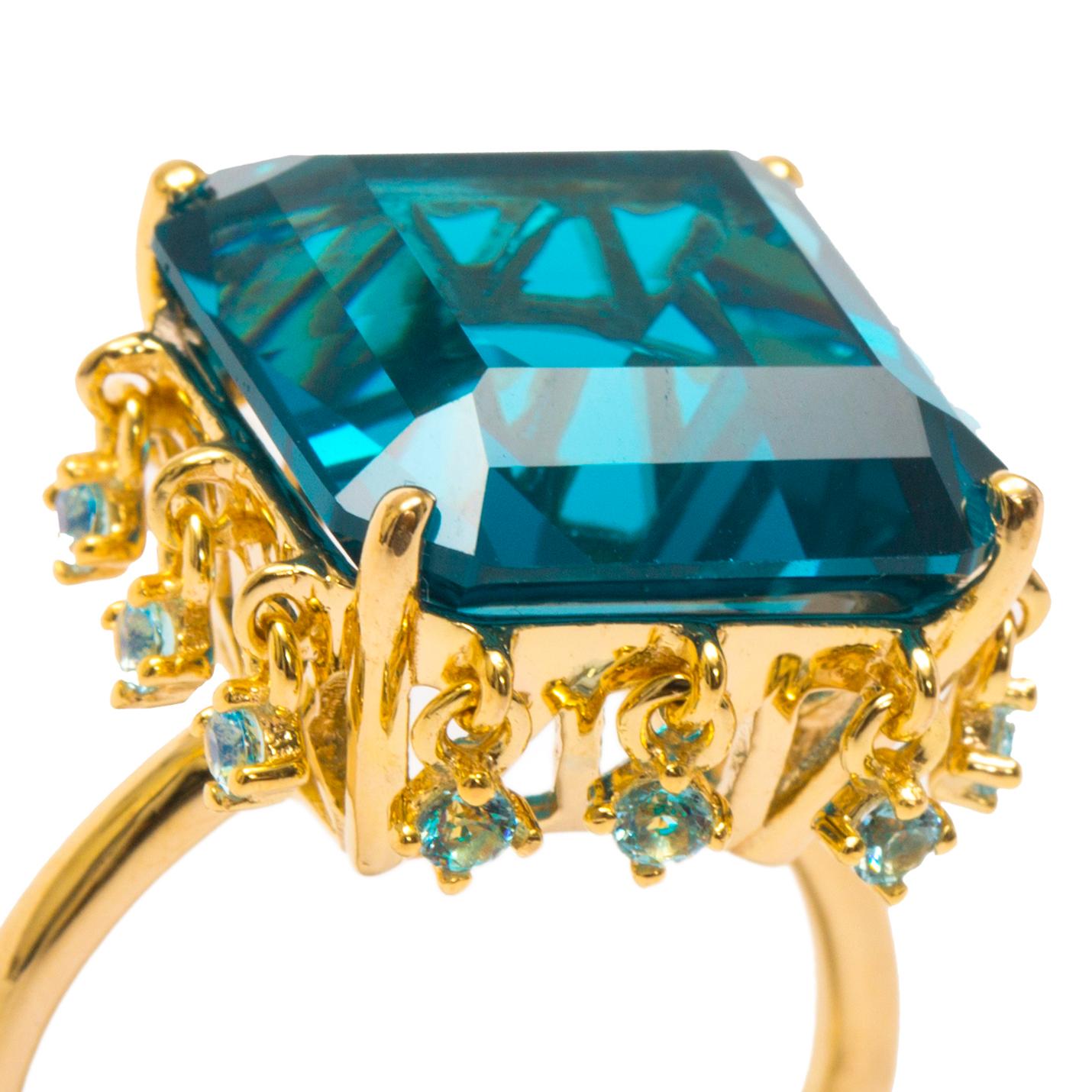Part of AMMANII new Malikat = Queens collection- inspired by the ruling females of ancient Egypt. A dazzling ring to signify the queen's crown. Hand crafted vermeil gold with hand cut statement blue topaz and charm stones around it. May the beauty