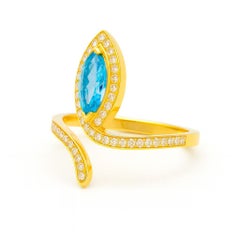 Blue topaz open ended ring in 14k gold
