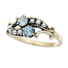 Anillo de dos piedras estilo vintage con topacio azul y perla en oro amarillo macizo de 9 quilates