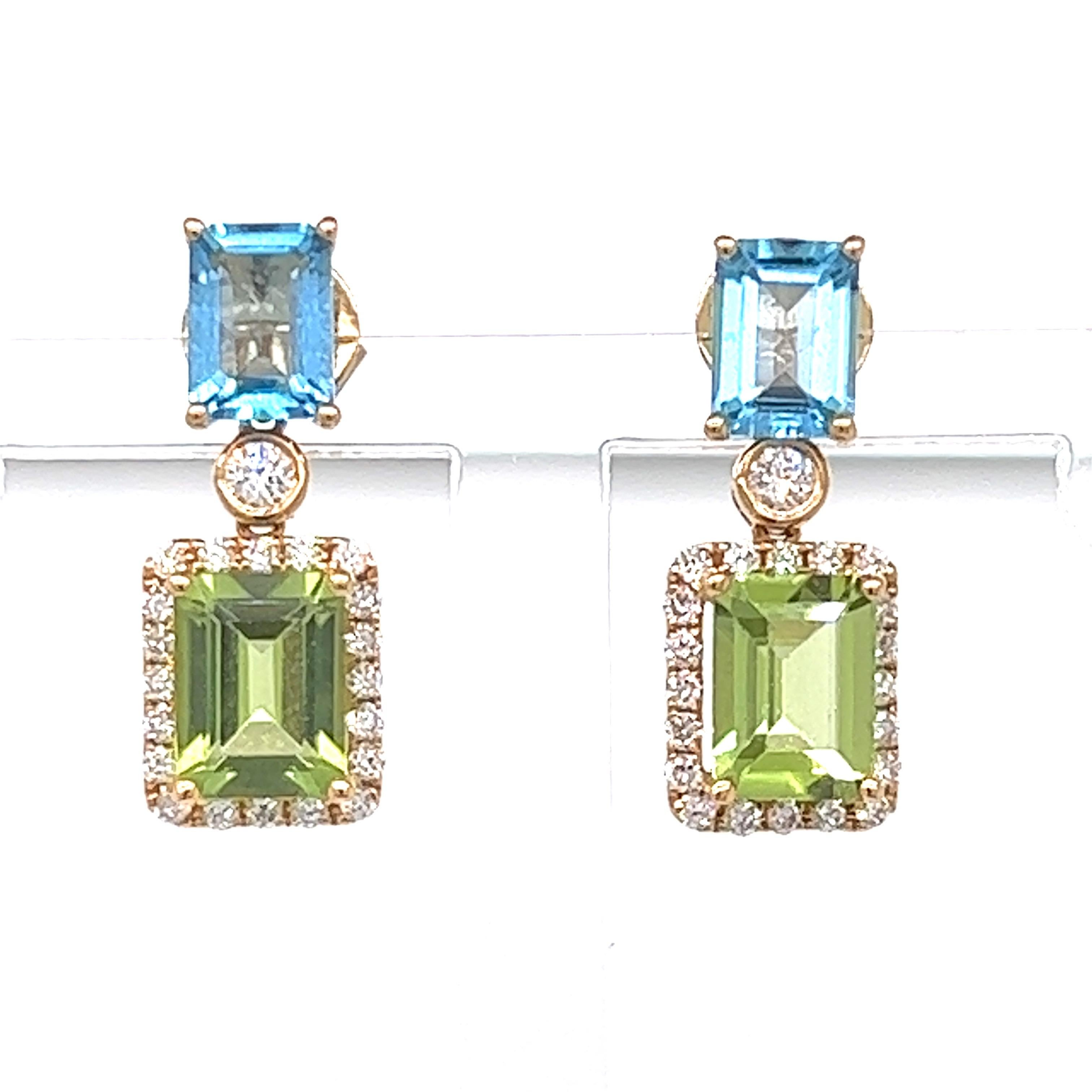 The color combination of blue topaz and peridot is stunning.  These beautifully crafted earrings are mounted in four grams of 18 kt yellow gold. There is .53 ctw of VS-SI clarity, G-H color diamonds surrounding 5.03 ctw of peridot and blue topaz.