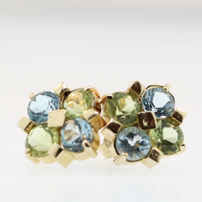 Sweet Peridot and Blue Topaz Gemstone Earring Studs. These earrings are so sweet and classy! With genuine peridots and blue topaz set in ornate prong settings and accented with with solid 14k yellow gold. These gemstone stud earrings are timeless