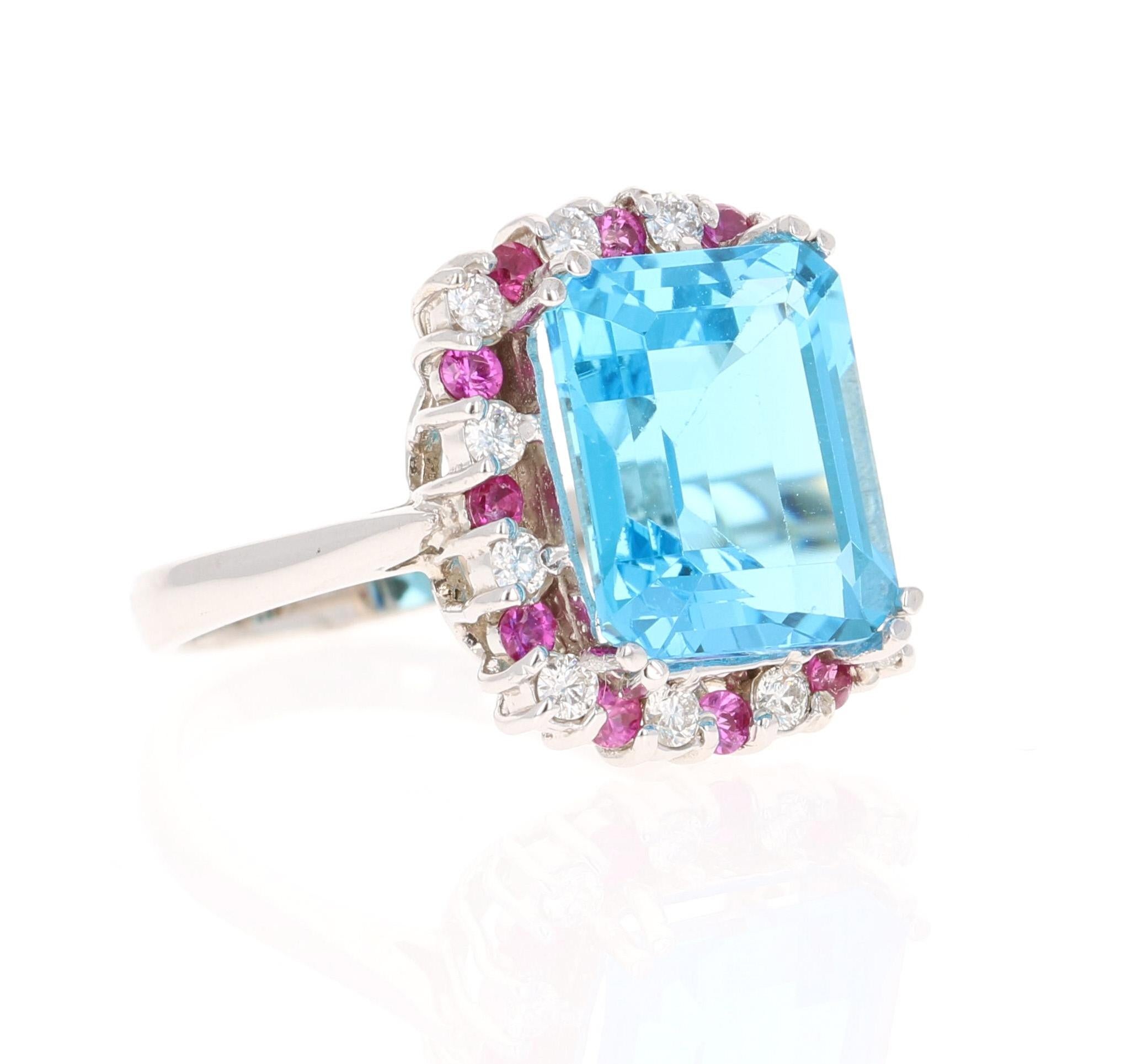 This stunning statement ring has a Emerald Cut Blue Topaz that weighs 8.15 carats. 
The blue topaz is 12 mm x 10 mm.  
It is surrounded by a halo of Pink Sapphires that weigh 0.40 carats and Diamonds that weigh 0.38 carats (Clarity: SI, Color: F)