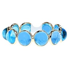 Fascia con cabochon rotondo di topazio blu, oro giallo