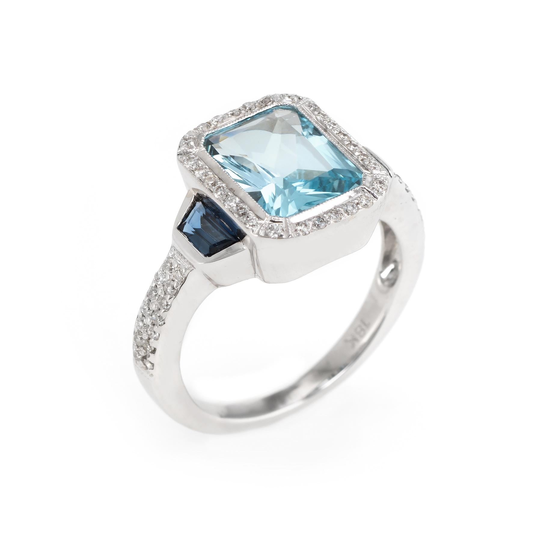 Finely detailed estate blue topaz, sapphire & diamond ring, crafted in 18 karat white gold. 

Centrally mounted cushion shaped blue topaz measures 9mm x 7mm (estimated at 3 carats), accented with two estimated 0.15 carat trapezoid shaped blue