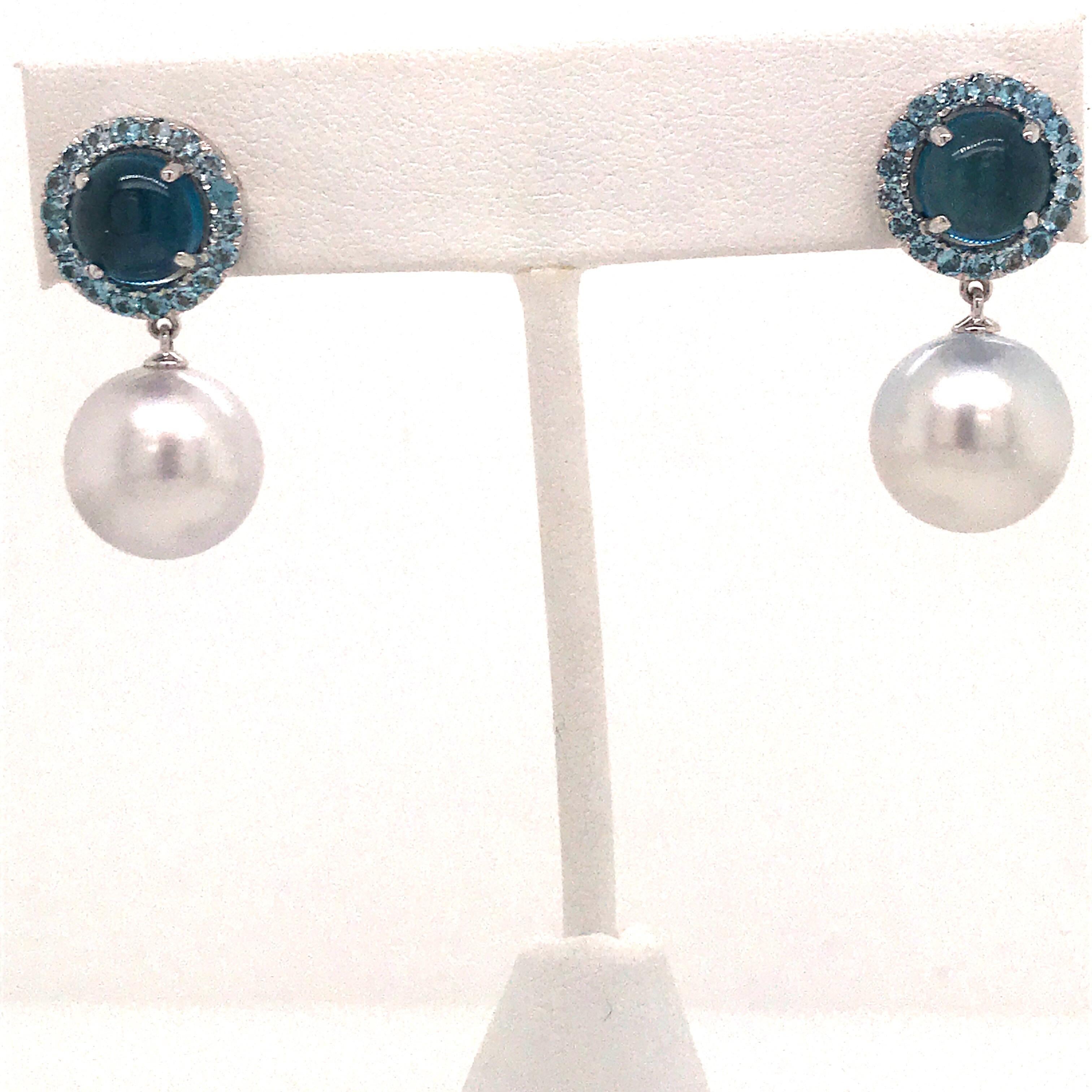18K White gold drop earrings featuring Blue Topaz weighing 6 carats and two South Sea Pearls measuring 12-13 mm. 