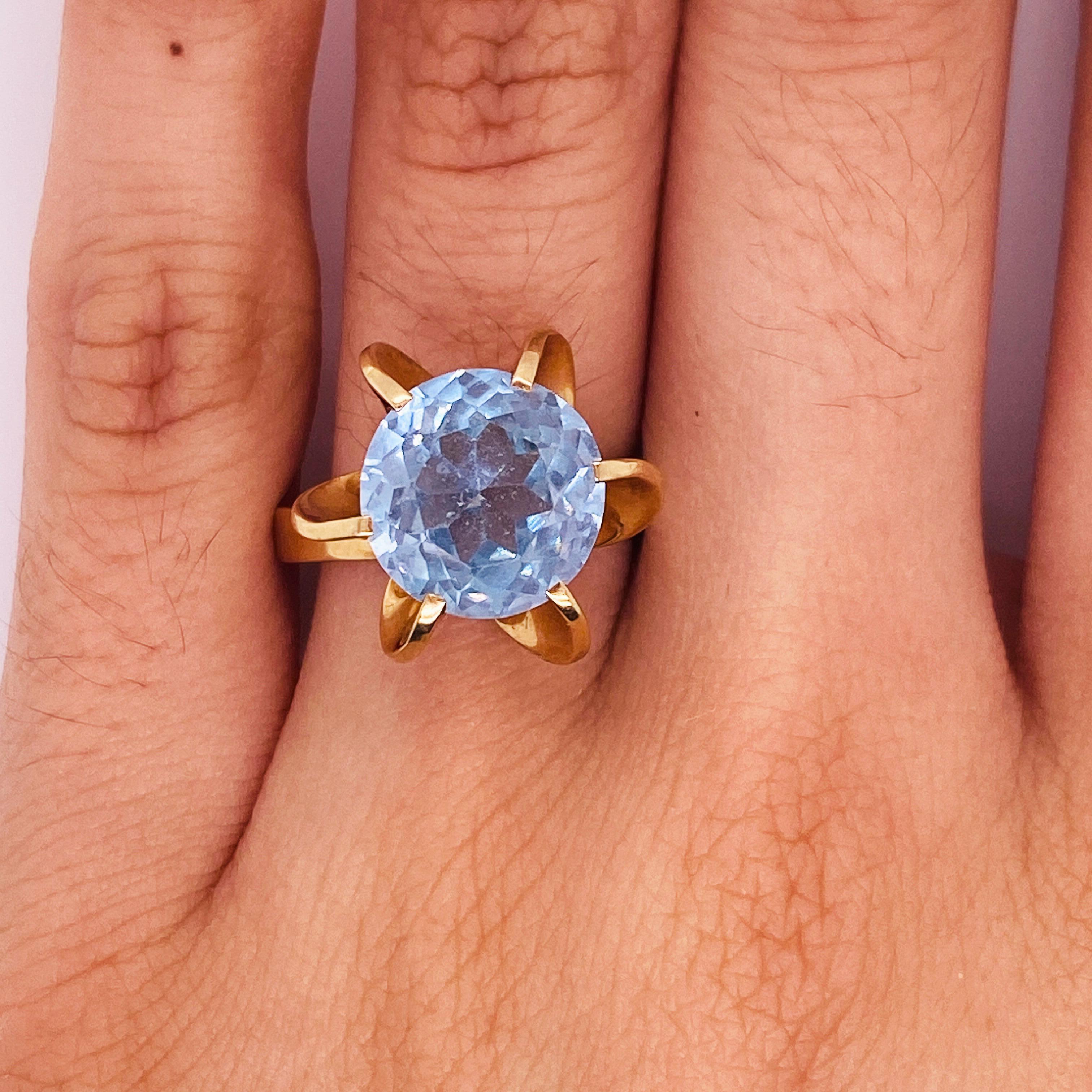 Adorn your look with this unusual blue topaz that is caught mid-spiral on your finger! Remember a breeze from a memory every time you look at the cool blue topaz in the center of this fabulous fan setting! Suspended in a moment, the twist to the
