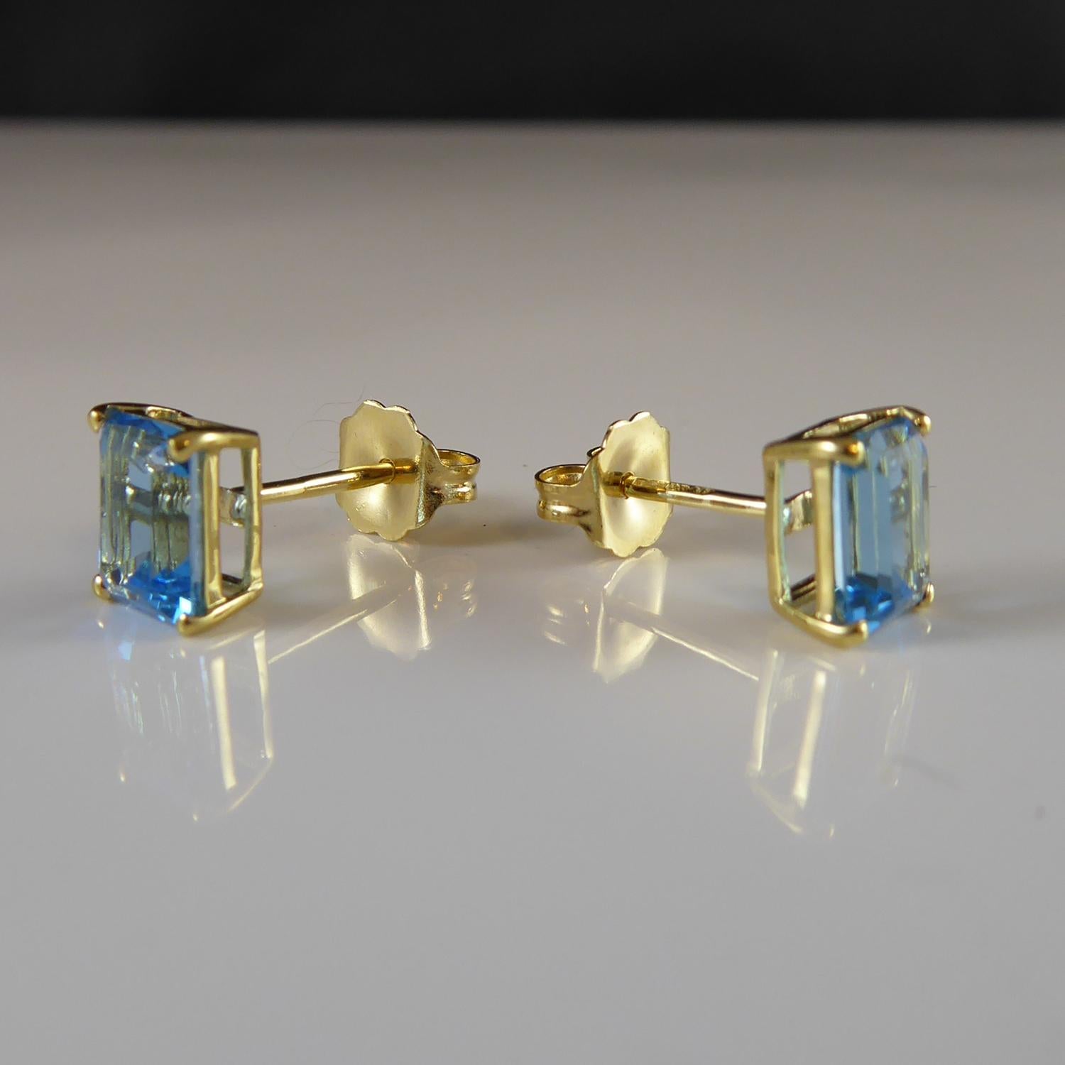 Emerald Cut Blue Topaz Stud Earrings in Yellow Gold