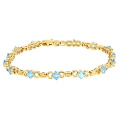 Bracelet tennis en or jaune 14 carats avec topaze bleue