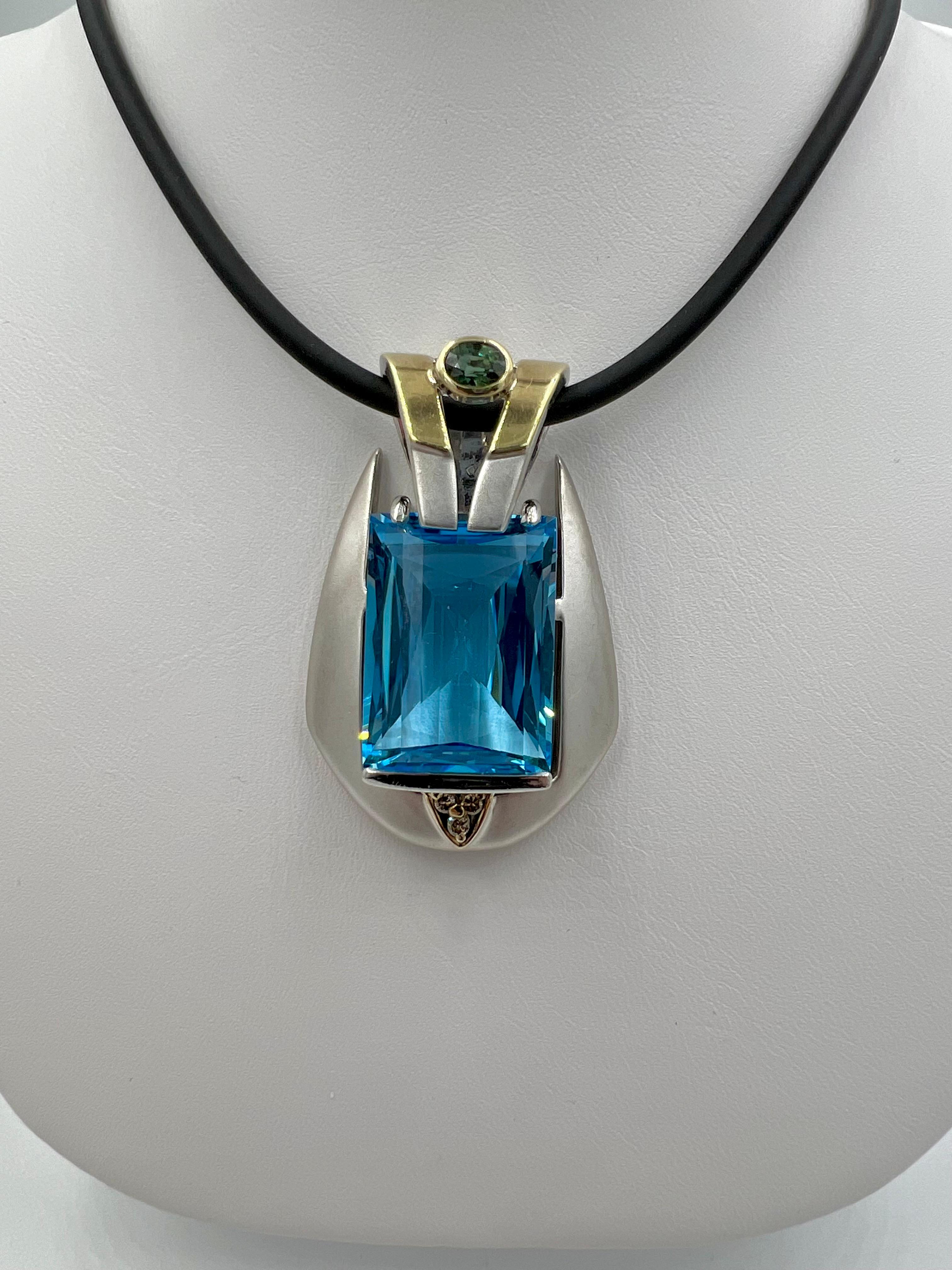 Blue Topaz Tourmaline Diamond silver and yellow gold slide pendant, circa 1990s.

   This Blue Topaz pendant is one show stopper! The scale and boldness along with fine hand made craftmanship make this pendant unique and one of a kind.  Not only is