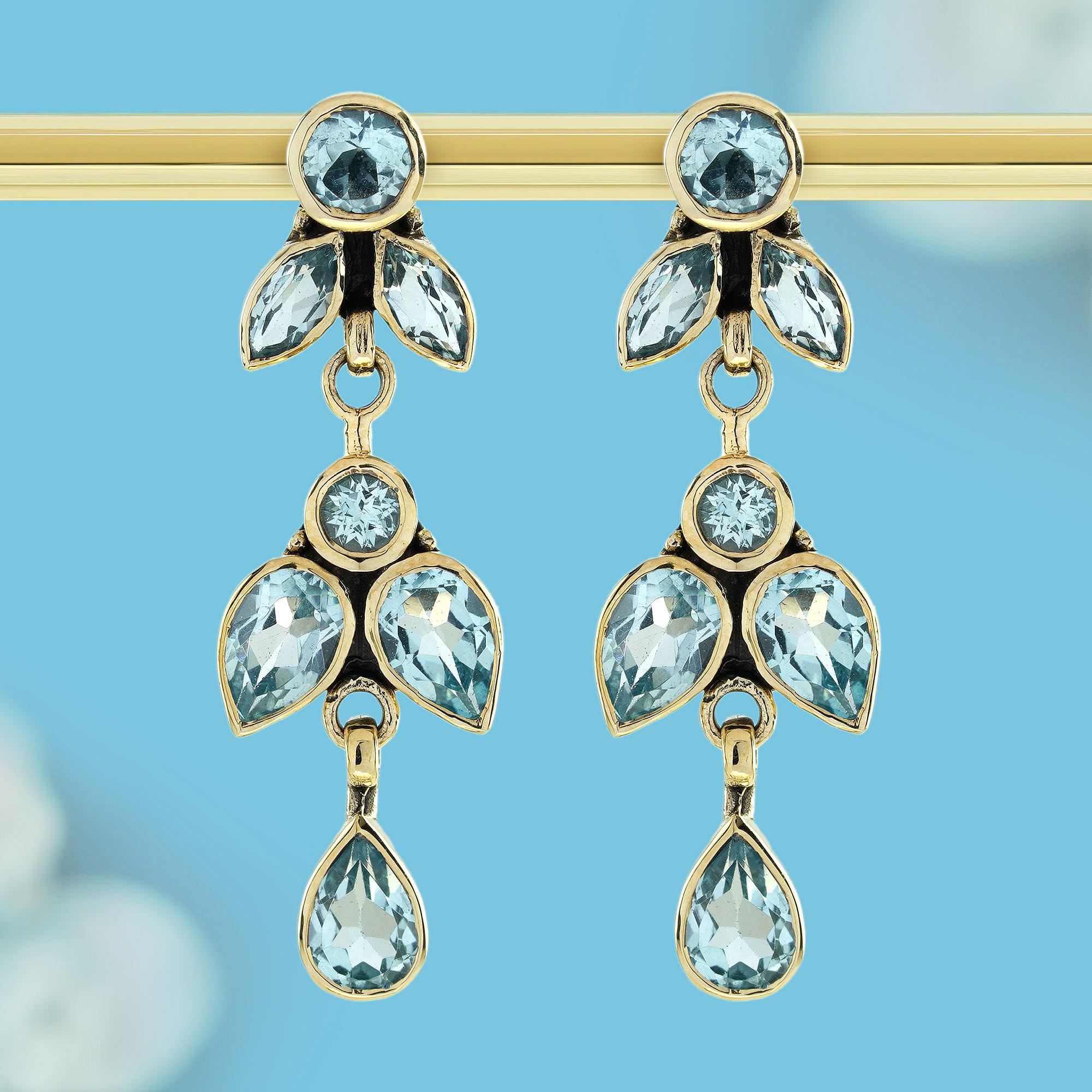 Transformación y belleza. Inspirados en la delicada gracia de las mariposas, cada pendiente está adornado con un vibrante topacio azul, que recuerda a un cielo sereno en un día despejado. El diseño de inspiración vintage añade una sensación de