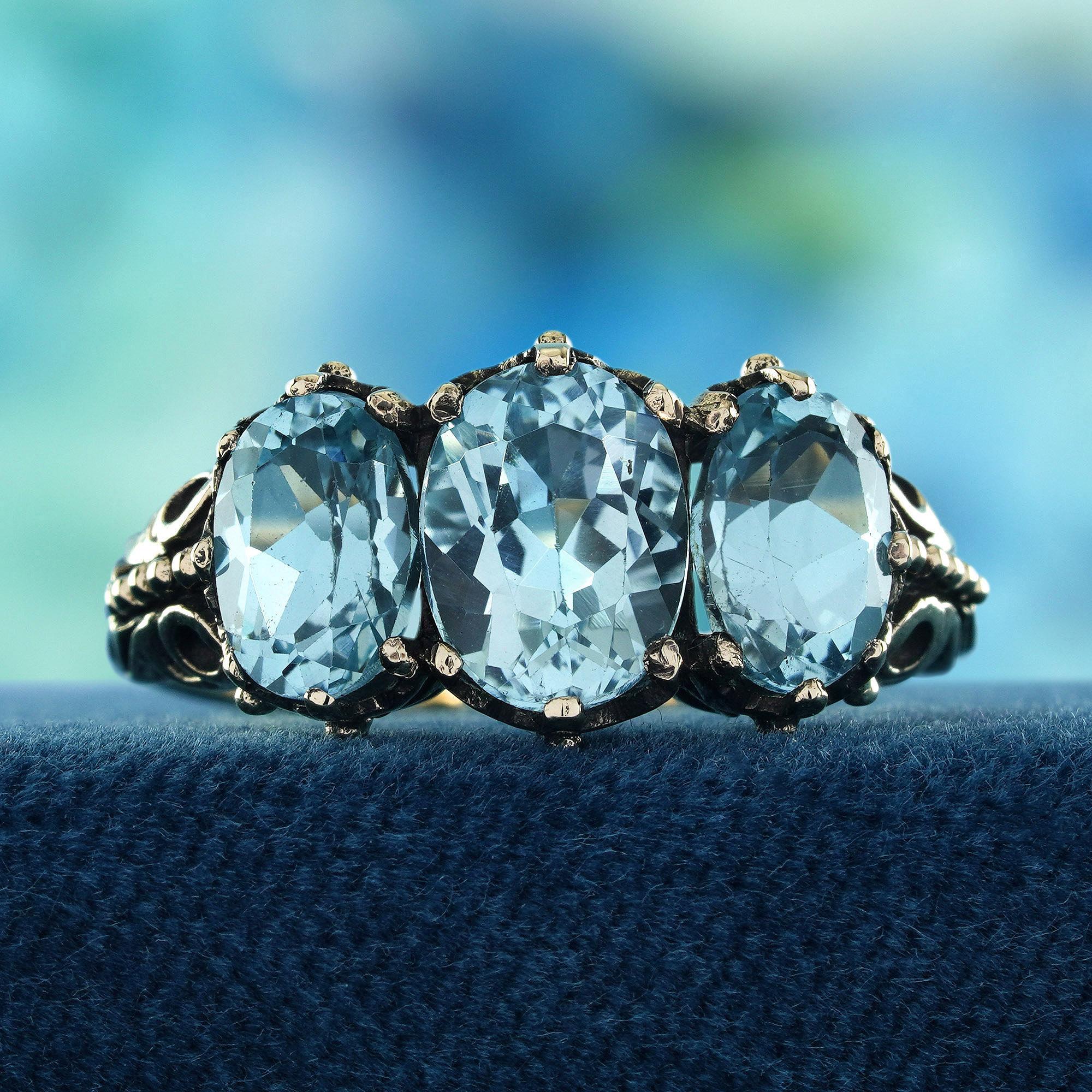 Elevate your elegance with our Natural Blue Topaz Vintage Style Three-Stone Ring in Solid 9K Yellow Gold. Featuring three stunning, vibrant blue topaz stones, this ring exudes timeless beauty and sophistication.
 The warm glow of 9K yellow gold