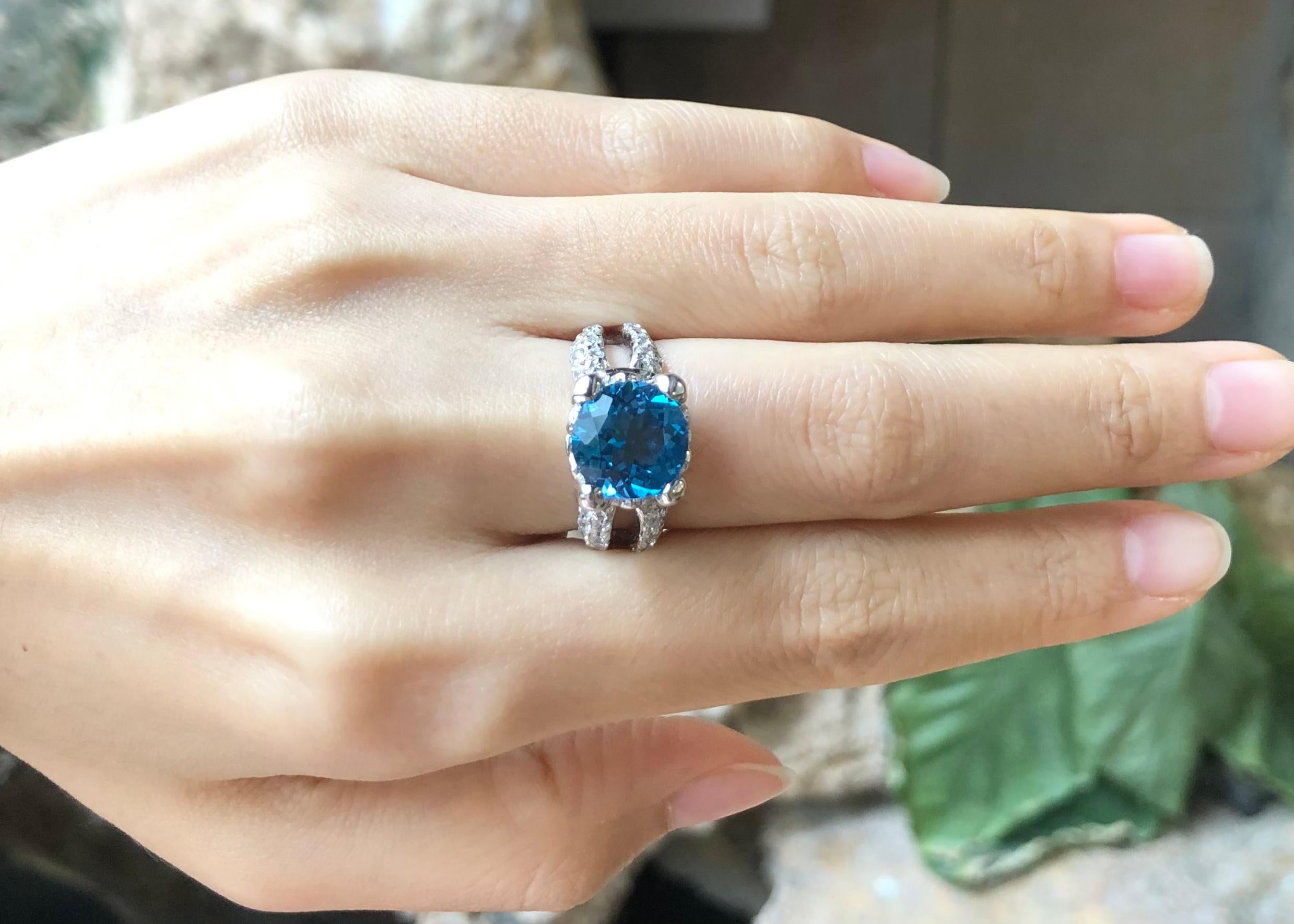 Blue Topaz with Cubic Zirconia Ring set in Silver Settings

Width:  1.2 cm 
Length: 1.1 cm
Ring Size: 55
Total Weight: 6.94 grams

*Please note that the silver setting is plated with rhodium to promote shine and help prevent oxidation.  However,