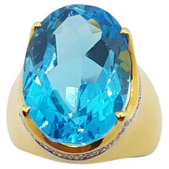 Bague en or 18 carats sertie d'une topaze bleue et de diamants