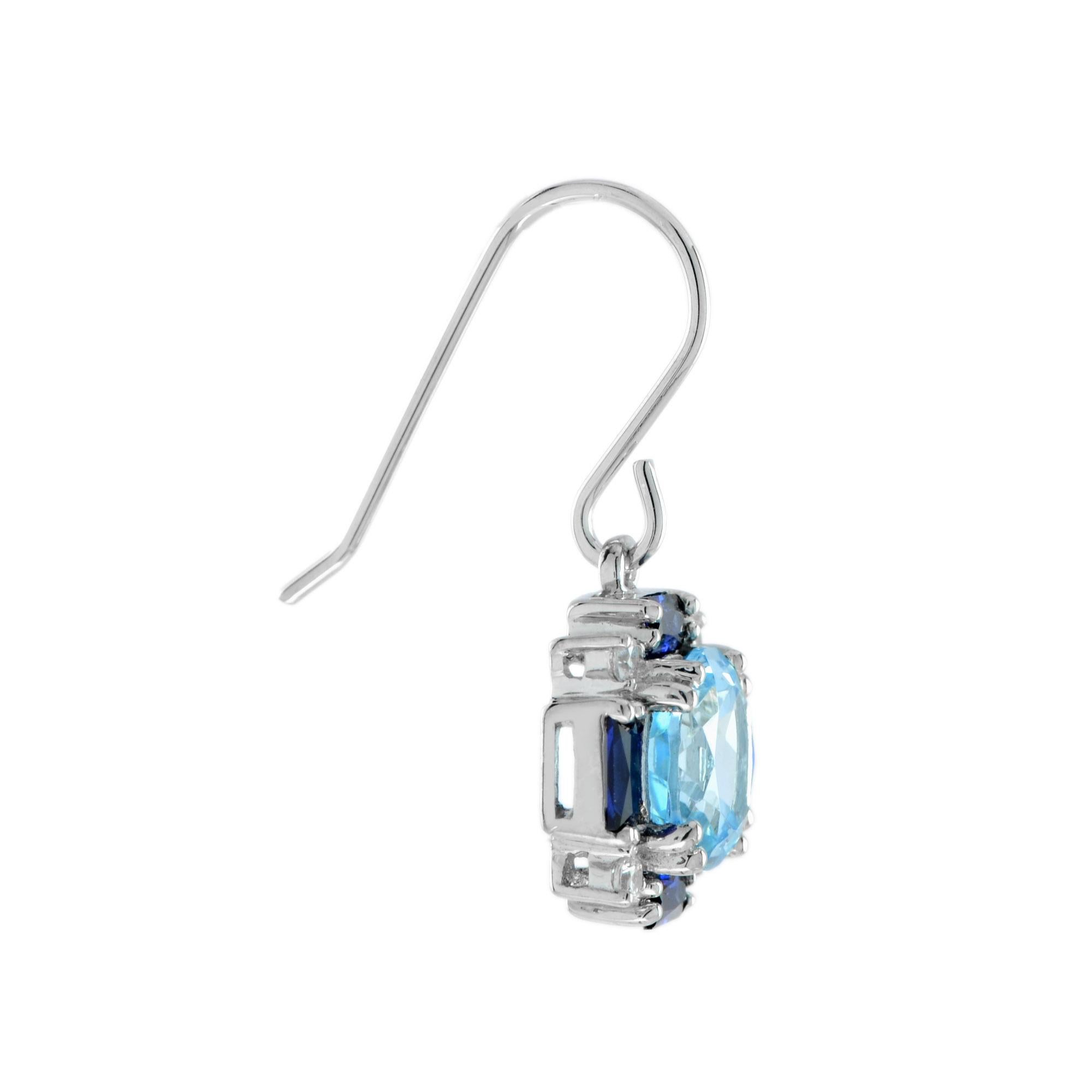 Exquisitely round cut blue topaz are handset into 14k white gold, bordered by blue baguette cut sapphires and round diamonds. A lovely pair to add colors to your day.

Earrings Information
Metal: 14K White Gold
Width: 12 mm.
Length: 26 mm.
Weight: